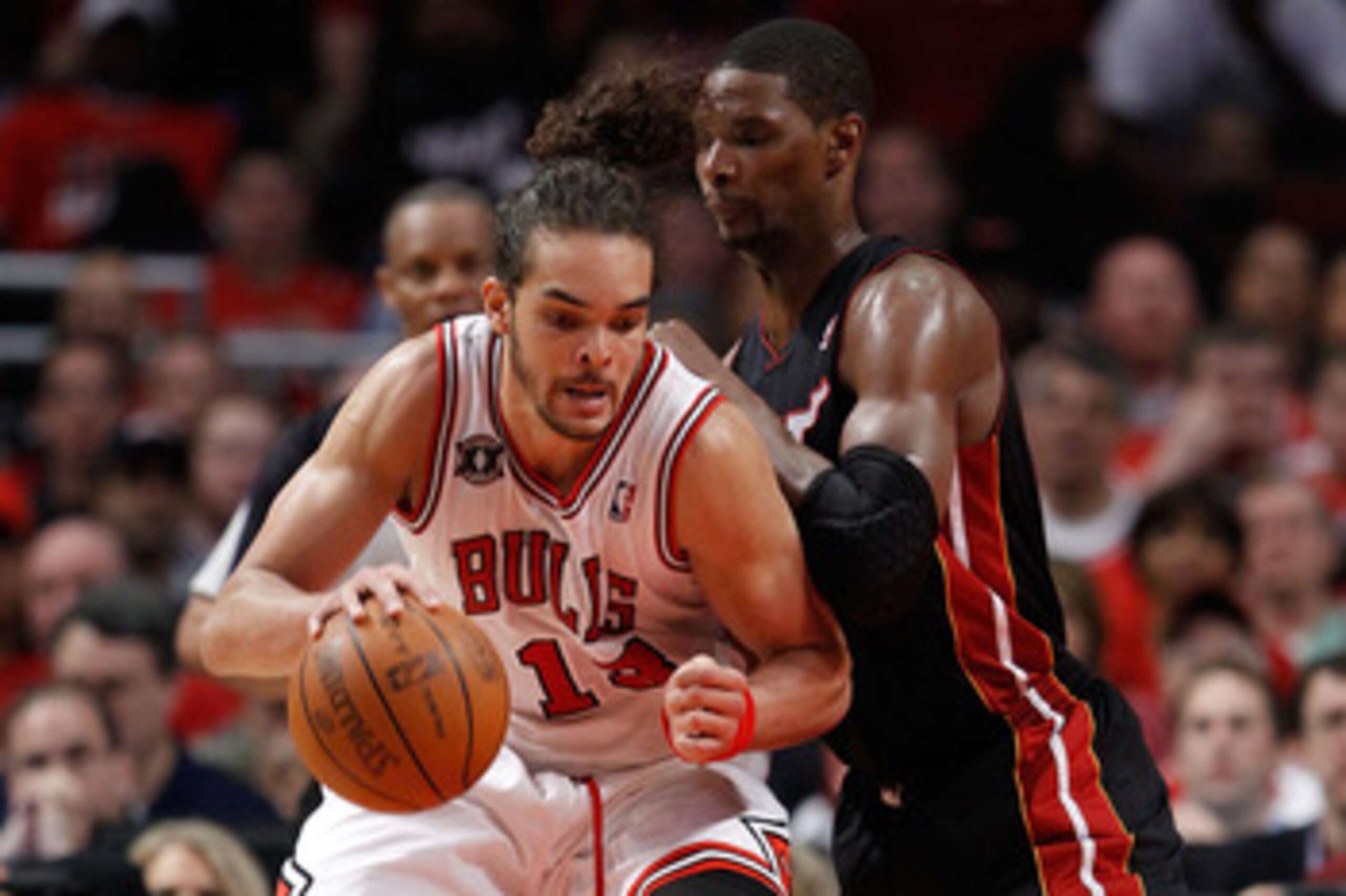 CHICAGO, IL - MAY 15:  Joakim Noah #13 of the Chicago Bulls posts up against Chris Bosh #1 of the Miami Heat in Game One of the Eastern Conference Finals during the 2011 NBA Playoffs on May 15, 2011 at the United Center in Chicago, Illinois. NOTE TO USER: