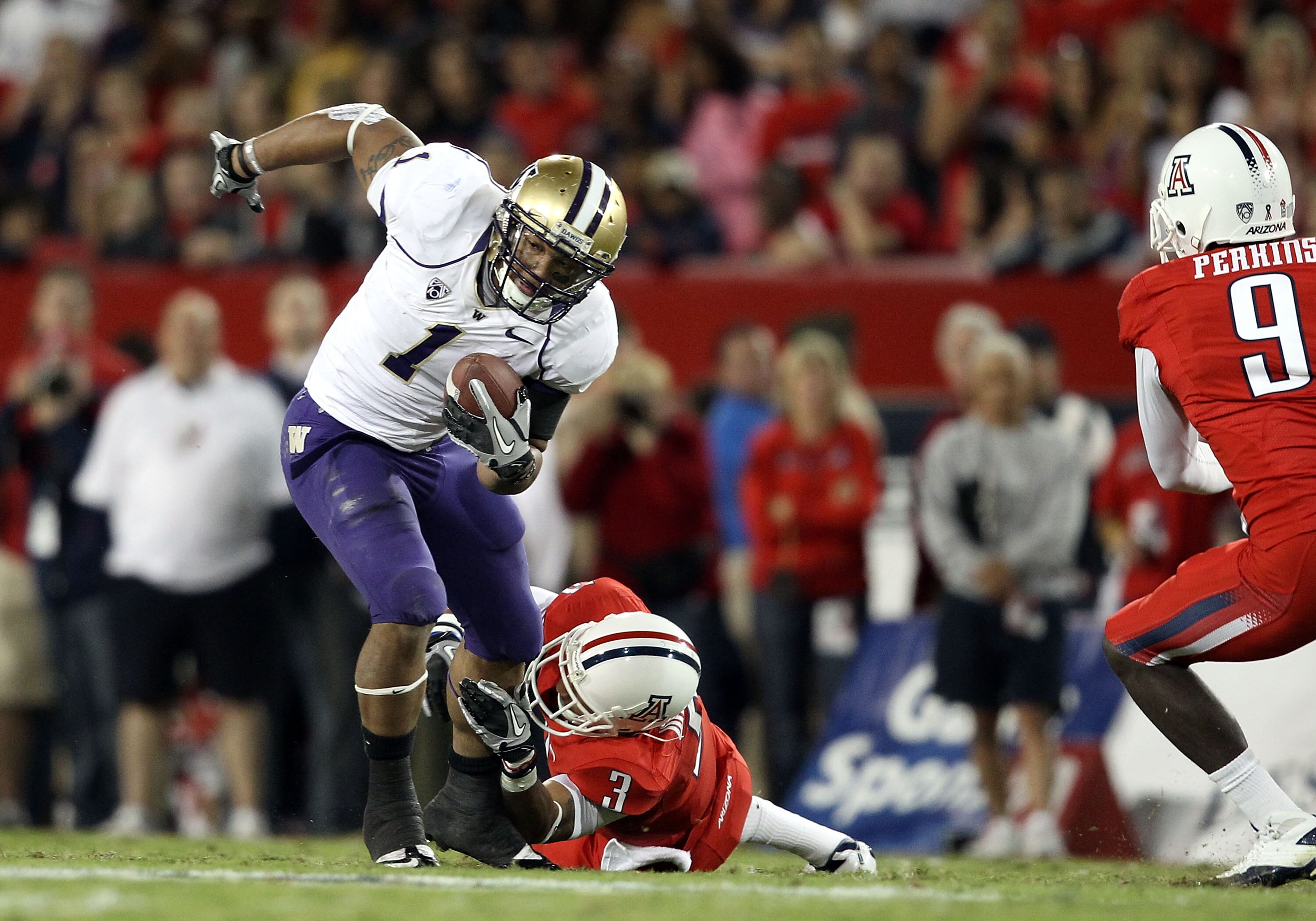 TUCSON, AZ - OCTOBER 23:  Runningback Chris Polk #1 of the Washington Huskies rushes the football during the college football game against the Arizona Wildcats at Arizona Stadium on October 23, 2010 in Tucson, Arizona. The Wildcats defeated the Huskies 44