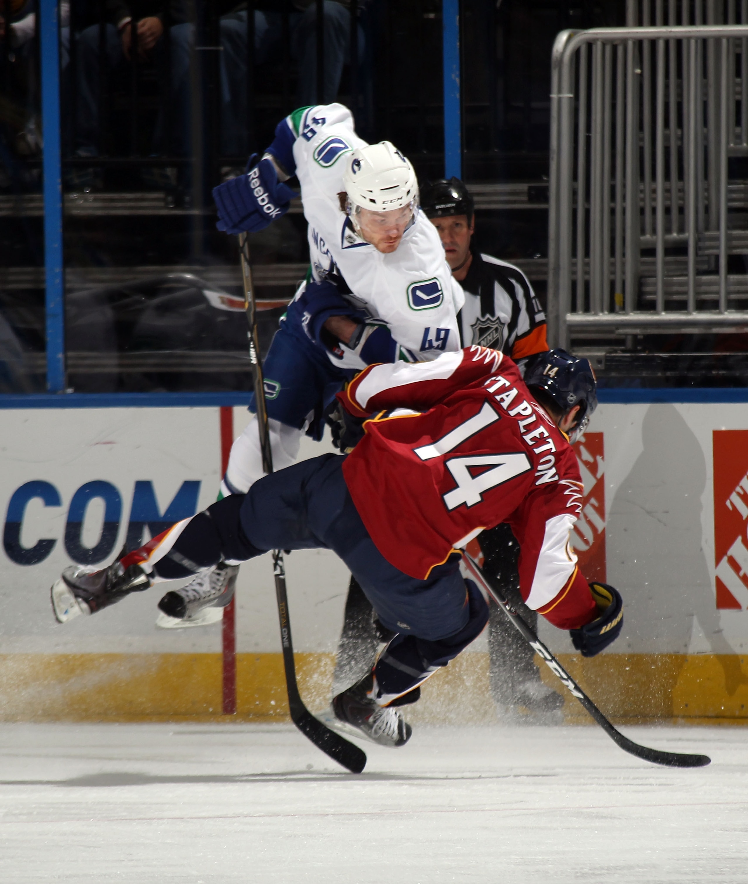 ATLANTA, GA - MARCH 25: Alex Bolduc #49 of the Vancouver Canucks hits Tim Stapleton #14 of the Atlanta Thrashers during first period action at the Philips Arena on March 25, 2011 in Atlanta, Georgia. (Photo by Bruce Bennett/Getty Images)
