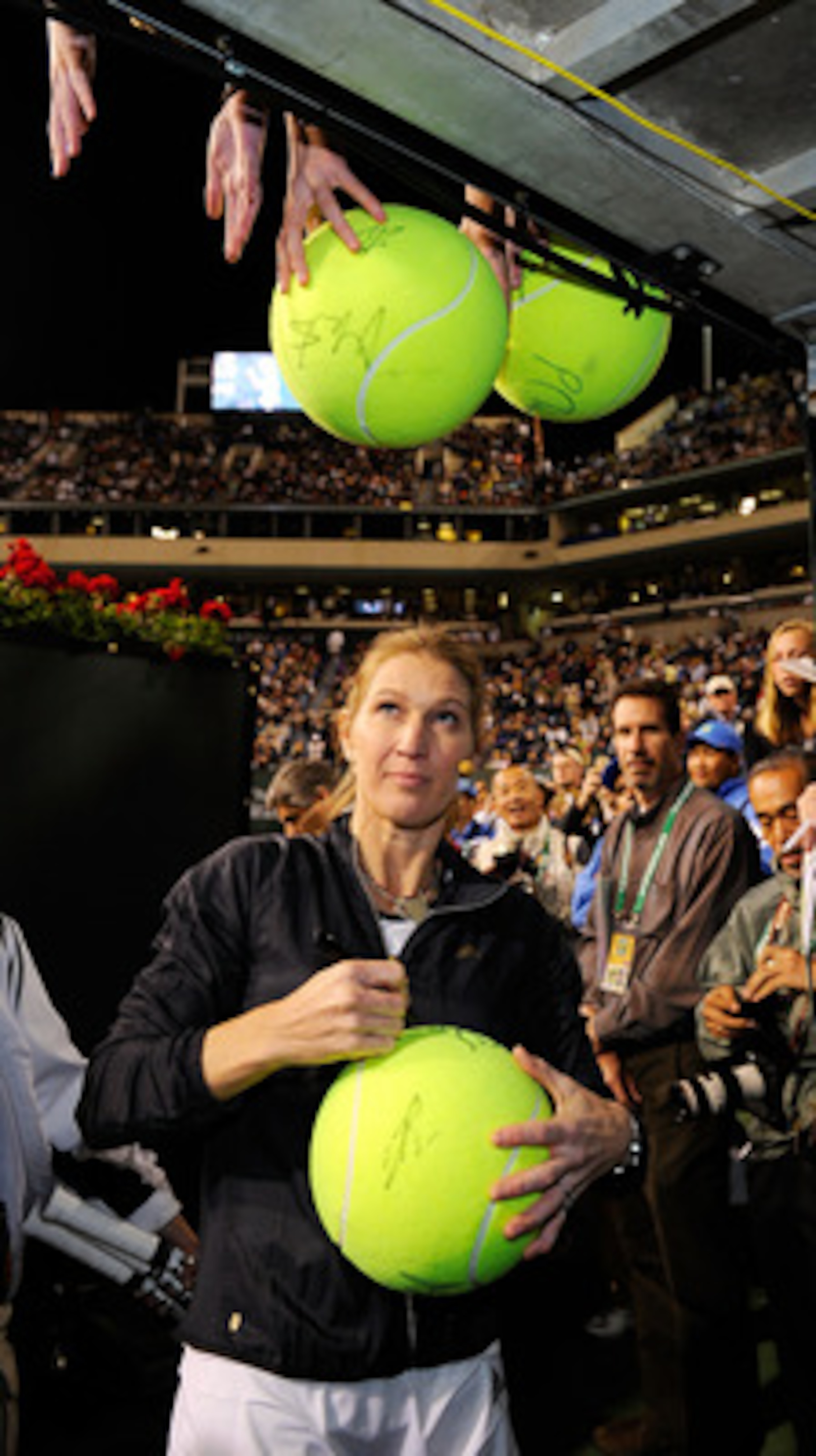 INDIAN WELLS, CA - MARCH 12:  Tennis legend Stefi Graf of Germany signs tennis balls after participating in Hit for Haiti, a charity event during the BNP Paribas Open on March 12, 2010 in Indian Wells, California.  (Photo by Kevork Djansezian/Getty Images
