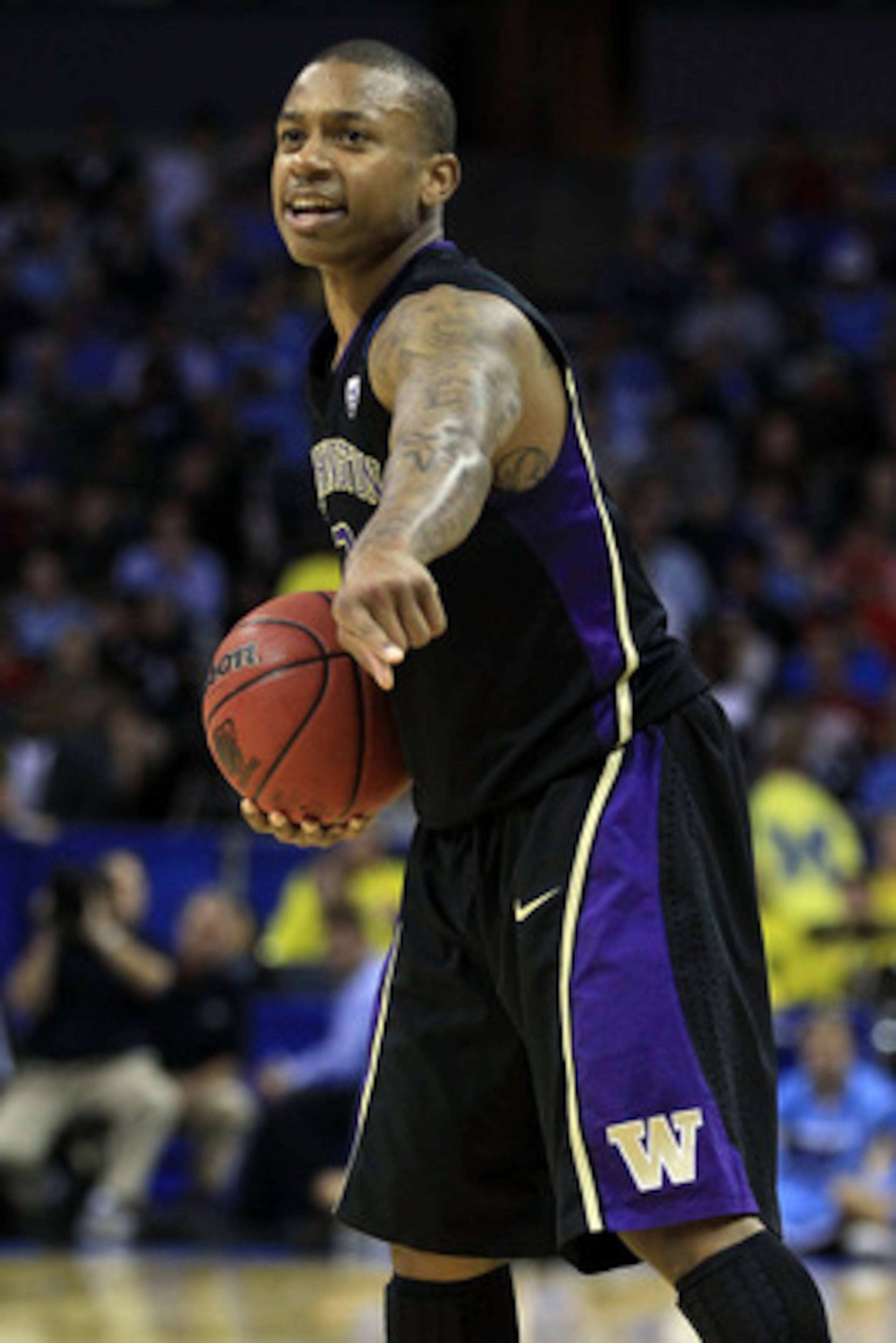 CHARLOTTE, NC - MARCH 20:  Isaiah Thomas #2 of the Washington Huskies points while taking on the North Carolina Tar Heels during the third round of the 2011 NCAA men's basketball tournament at Time Warner Cable Arena on March 20, 2011 in Charlotte, North 