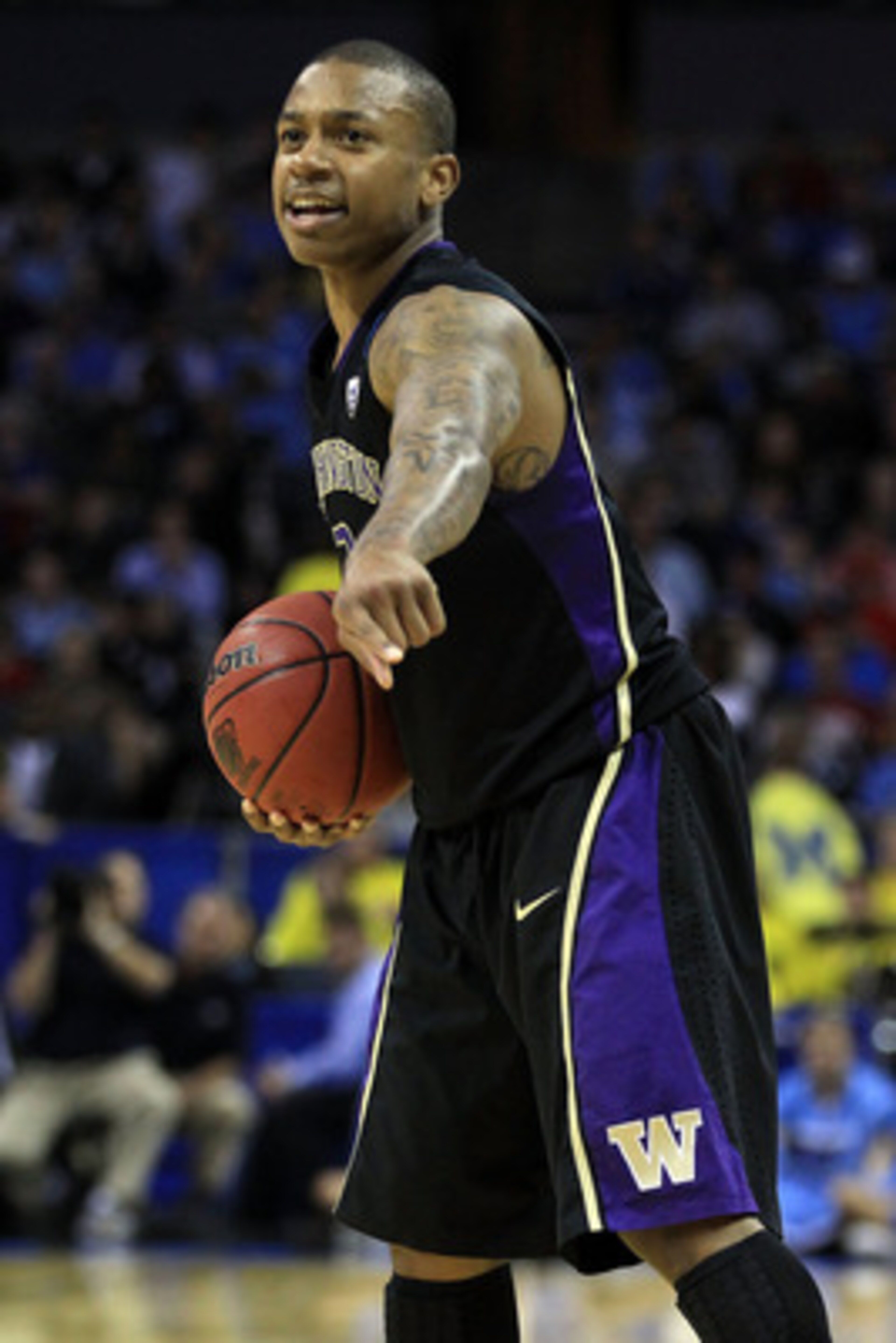 CHARLOTTE, NC - MARCH 20:  Isaiah Thomas #2 of the Washington Huskies points while taking on the North Carolina Tar Heels during the third round of the 2011 NCAA men's basketball tournament at Time Warner Cable Arena on March 20, 2011 in Charlotte, North 