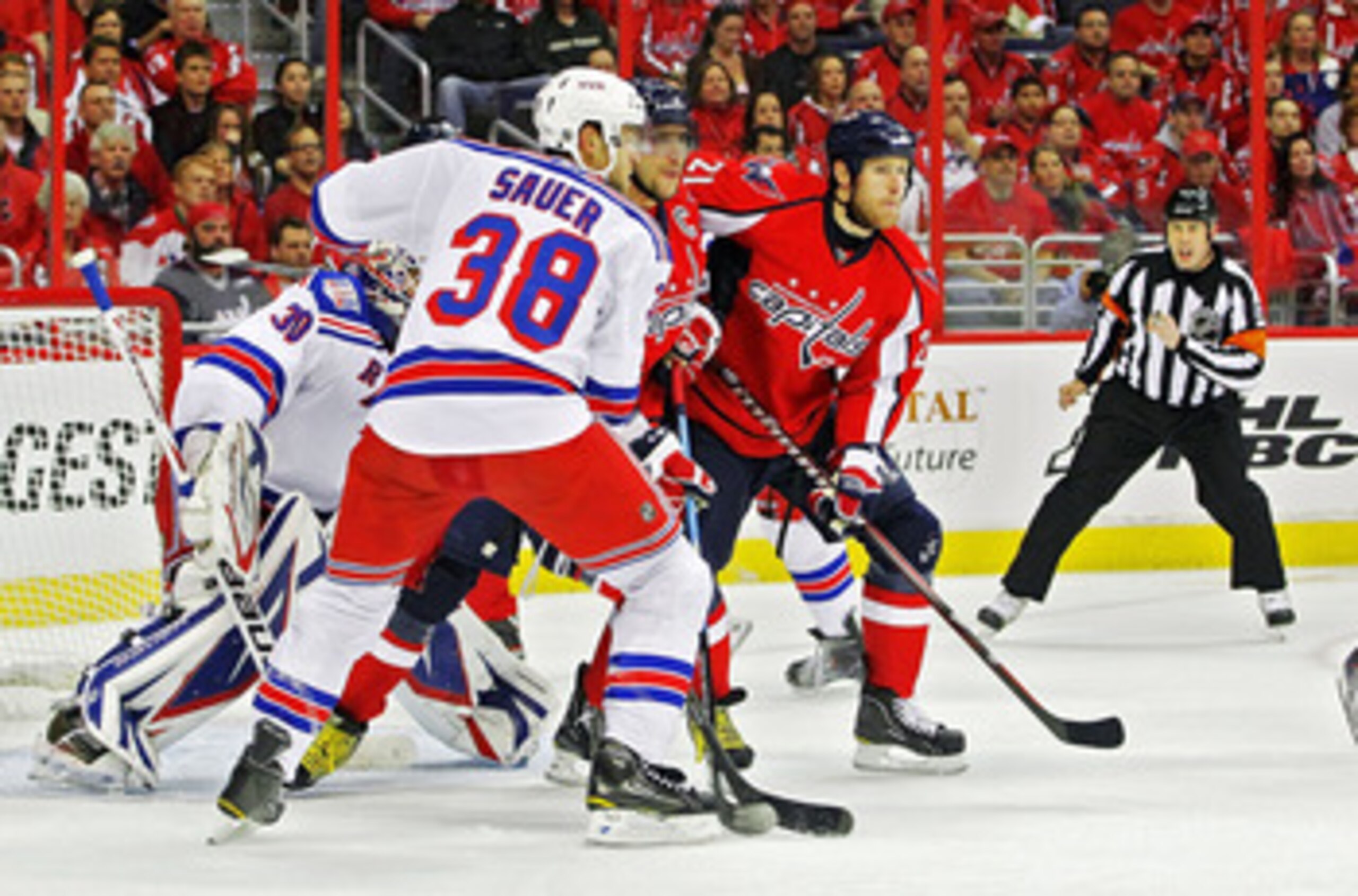 WASHINGTON , DC - APRIL 23: Brooks Laich #21 and Alex Ovechkin #8 of the Washington Capitals battle in the crease against Michael Sauer #38 and Henrik Lundqvist #30 of the New York Rangers in Game Five of the Eastern Conference Quarterfinals during the 20