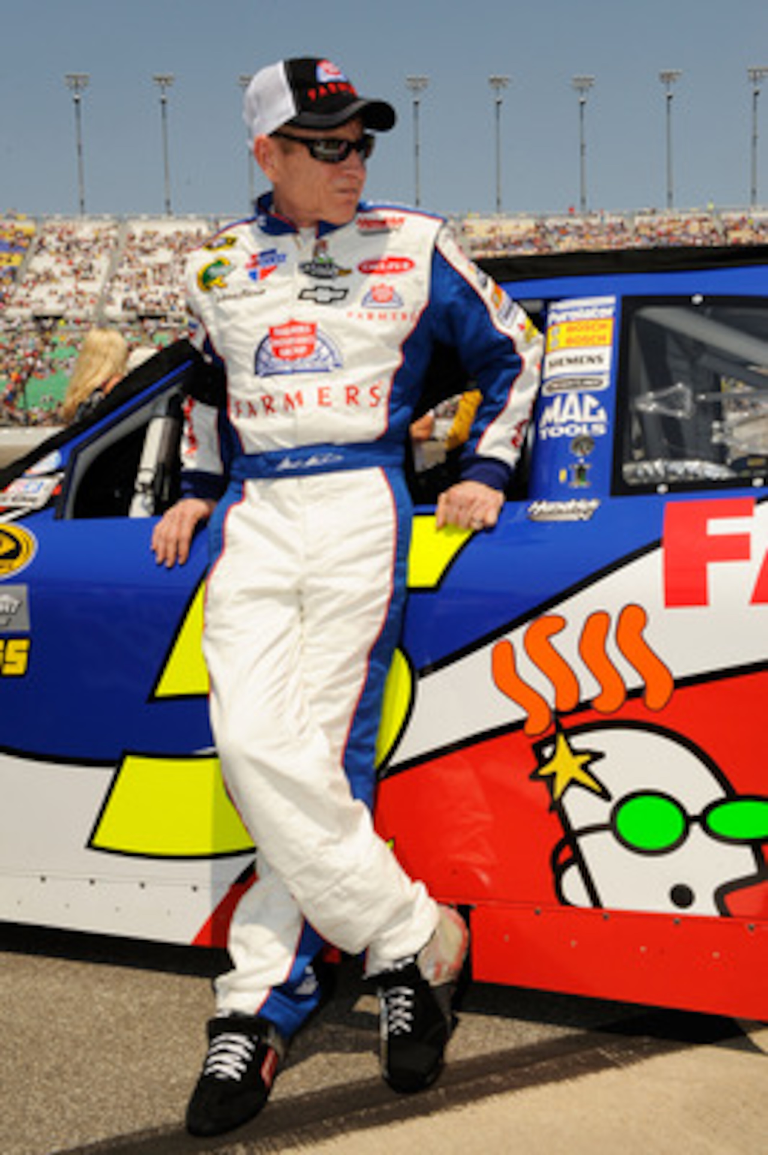 KANSAS CITY, KS - JUNE 05:  Mark Martin, driver of the #5 Farmers Insurance/GoDaddy.com Chevrolet, stands on the grid prior to the NASCAR Sprint Cup Series STP 400 at Kansas Speedway on June 5, 2011 in Kansas City, Kansas.  (Photo by John Harrelson/Getty 