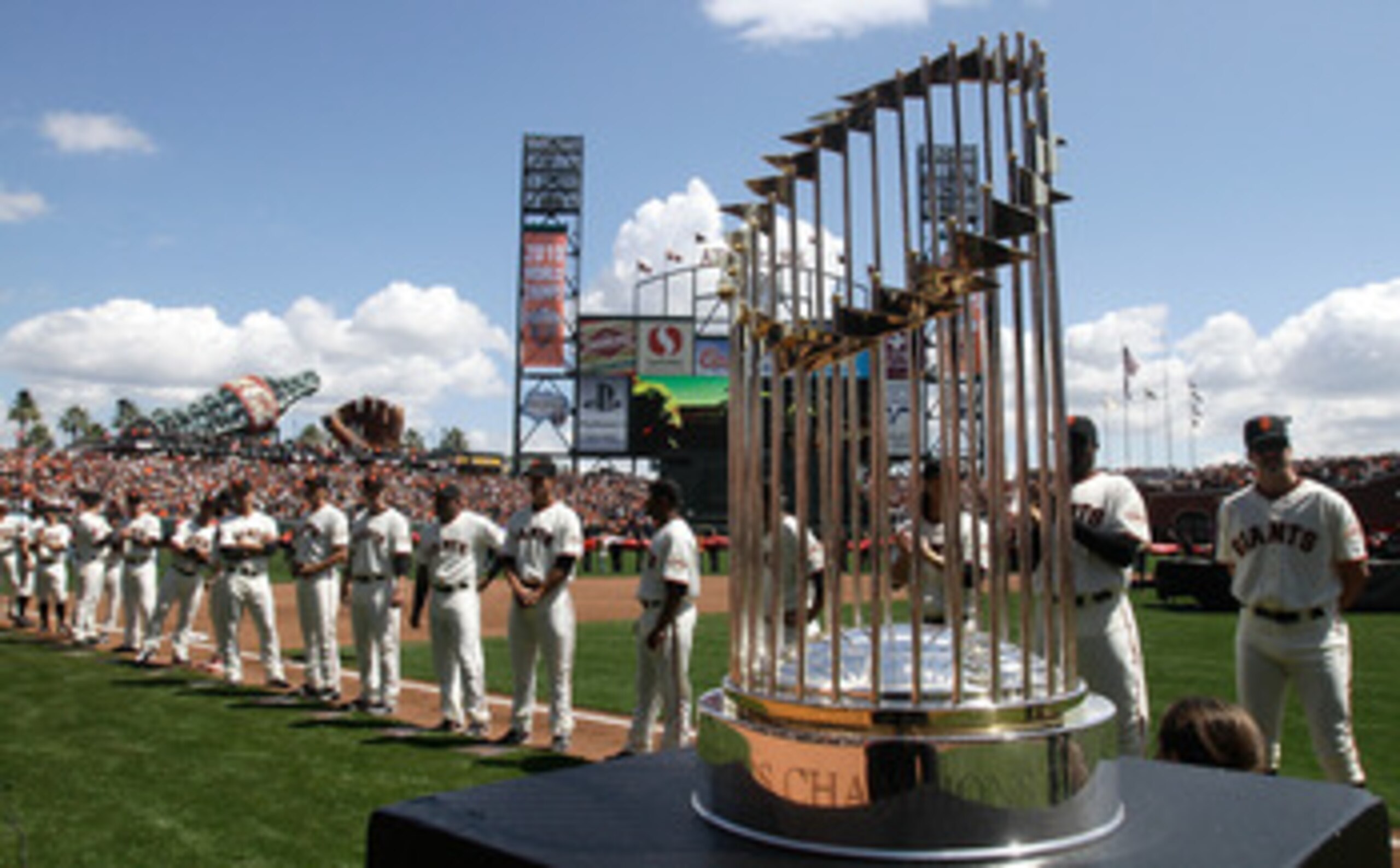 SAN FRANCISCO, CA - APRIL 08:  The 2010 World Series trophy is displayed as San Francisco Giants players line up before the start of the Giants' opening day game against the St. Louis Cardinals at AT&T Park on April 8, 2011 in San Francisco, California.  