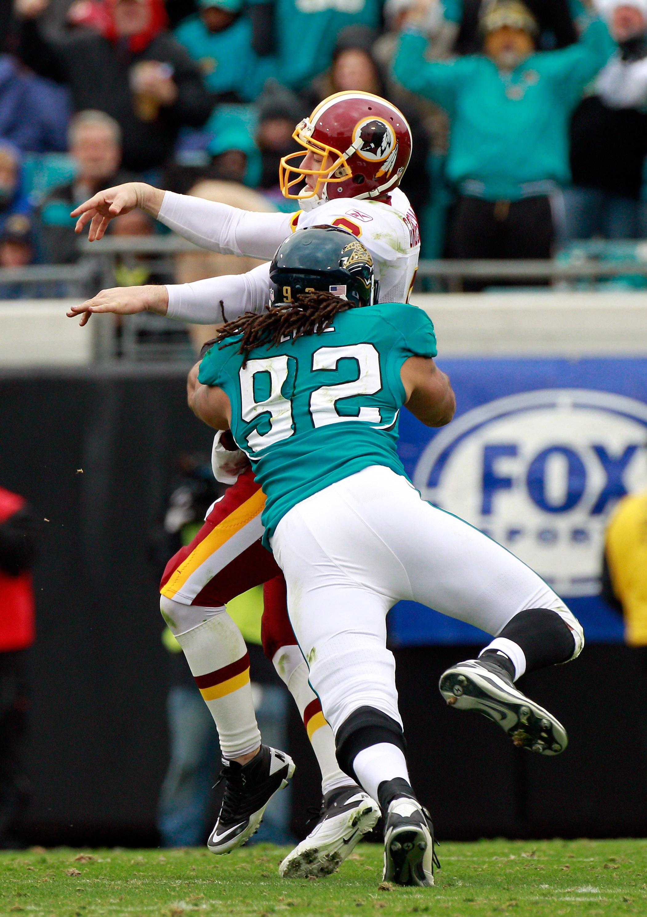 JACKSONVILLE, FL - DECEMBER 26:  Austen Lane #92 of the Jacksonville Jaguars tackles Rex Grossman #8 of the Washington Redskins during the game at EverBank Field on December 26, 2010 in Jacksonville, Florida.  (Photo by Sam Greenwood/Getty Images)