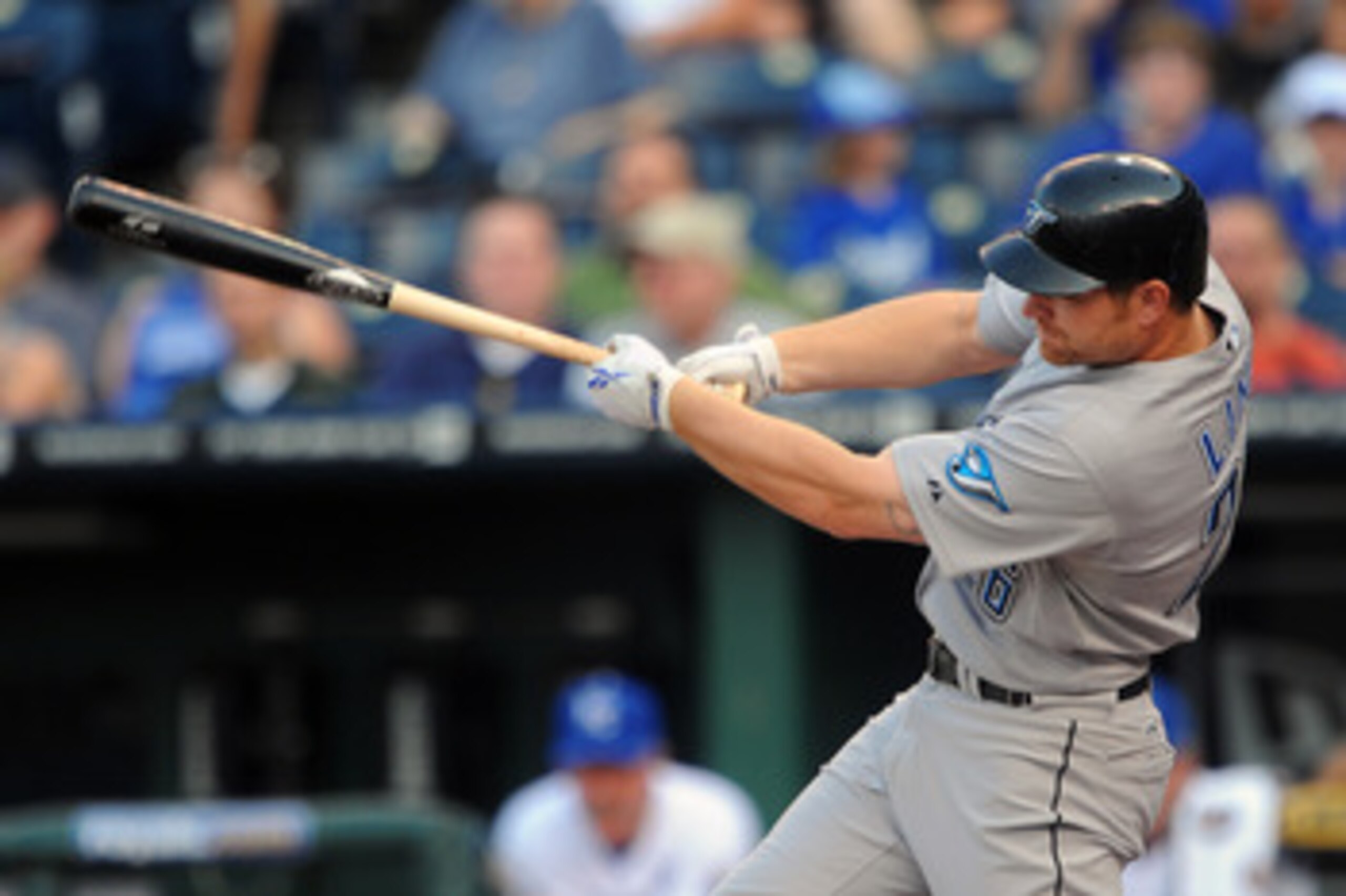 KANSAS CITY, MO - JUNE 7:  Adam Lind #26 of the Toronto Blue Jays follows through on a two-run home run in the first inning against the Kansas City Royals at Kauffman Stadium on June 7, 2011 in Kansas City, Missouri. (Photo by G. Newman Lowrance/Getty Ima