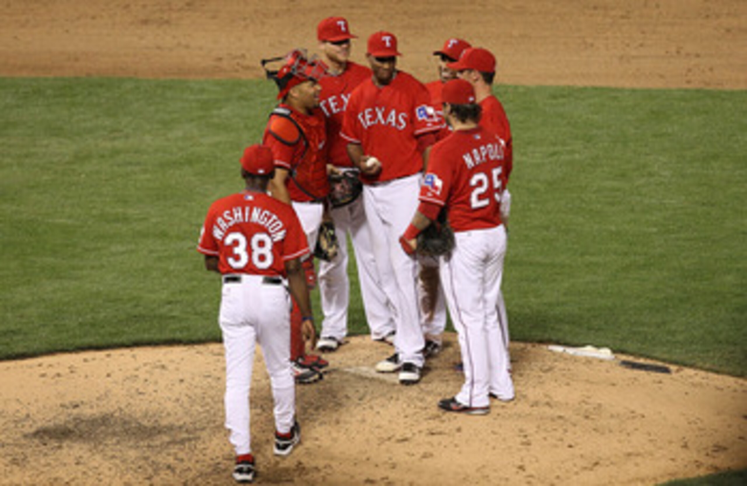 ARLINGTON, TX - JUNE 08:  Ron Washington #38 of the Texas Rangers walks to the mound to get Alexi Ogando #41 of the Texas Rangers during play against the Detroit Tigers at Rangers Ballpark in Arlington on June 8, 2011 in Arlington, Texas.  (Photo by Ronal