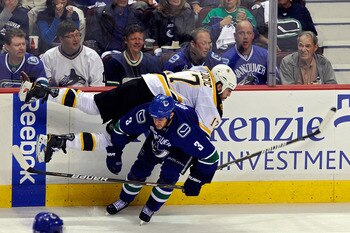 VANCOUVER, BC - JUNE 10:  Milan Lucic #17 of the Boston Bruins gets checked by Kevin Bieksa #3 of the Vancouver Canucks during Game Five of the 2011 NHL Stanley Cup Final at Rogers Arena on June 10, 2011 in Vancouver, British Columbia, Canada.  (Photo by 