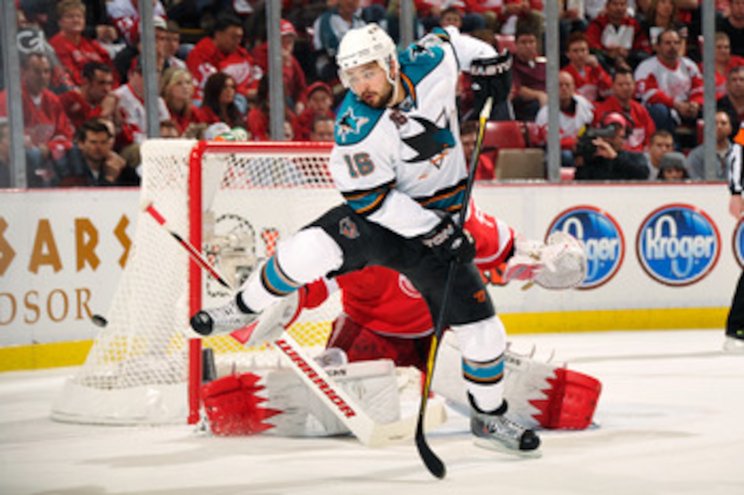 DETROIT - MAY 4:  Devin Setoguchi #16 of the San Jose Sharks attempts to screen goaltender Jimmy Howard #35 of the Detroit Red Wings in the first period in Game Three of the Western Conference Semifinals during the 2011 NHL Stanley Cup Playoffs on May 4, 