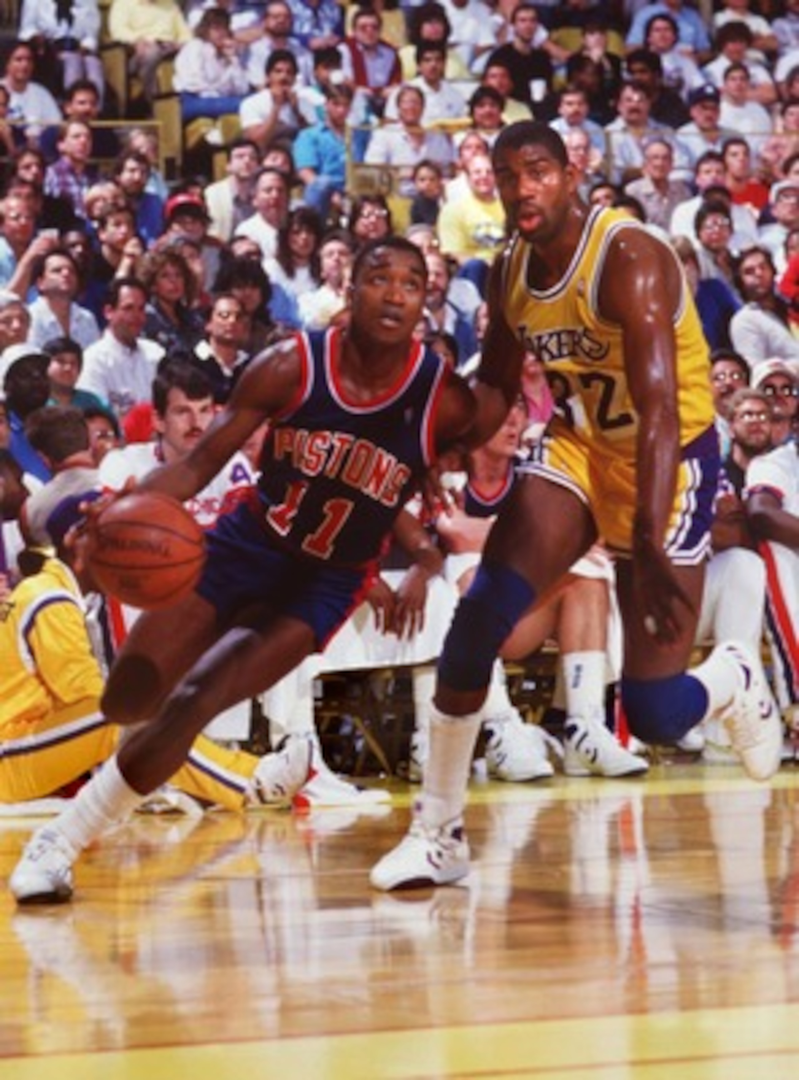 1987:  ISIAH THOMAS OF THE DETROIT PISTONS DRIVES PAST MAGIC JOHNSON OF THE LAKERS. Mandatory Credit: Rick Stewart/ALLSPORT