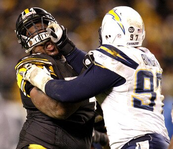 PITTSBURGH - NOVEMBER 16:  Willie Colon #74 of the Pittsburgh Steelers has his helmet pushed up while blocking by Ryon Bingham #97 of the San Diego Chargers on November 16, 2008 at Heinz Field in Pittsburgh, Pennsylvania. Pittsburgh won the game 11-10. (P
