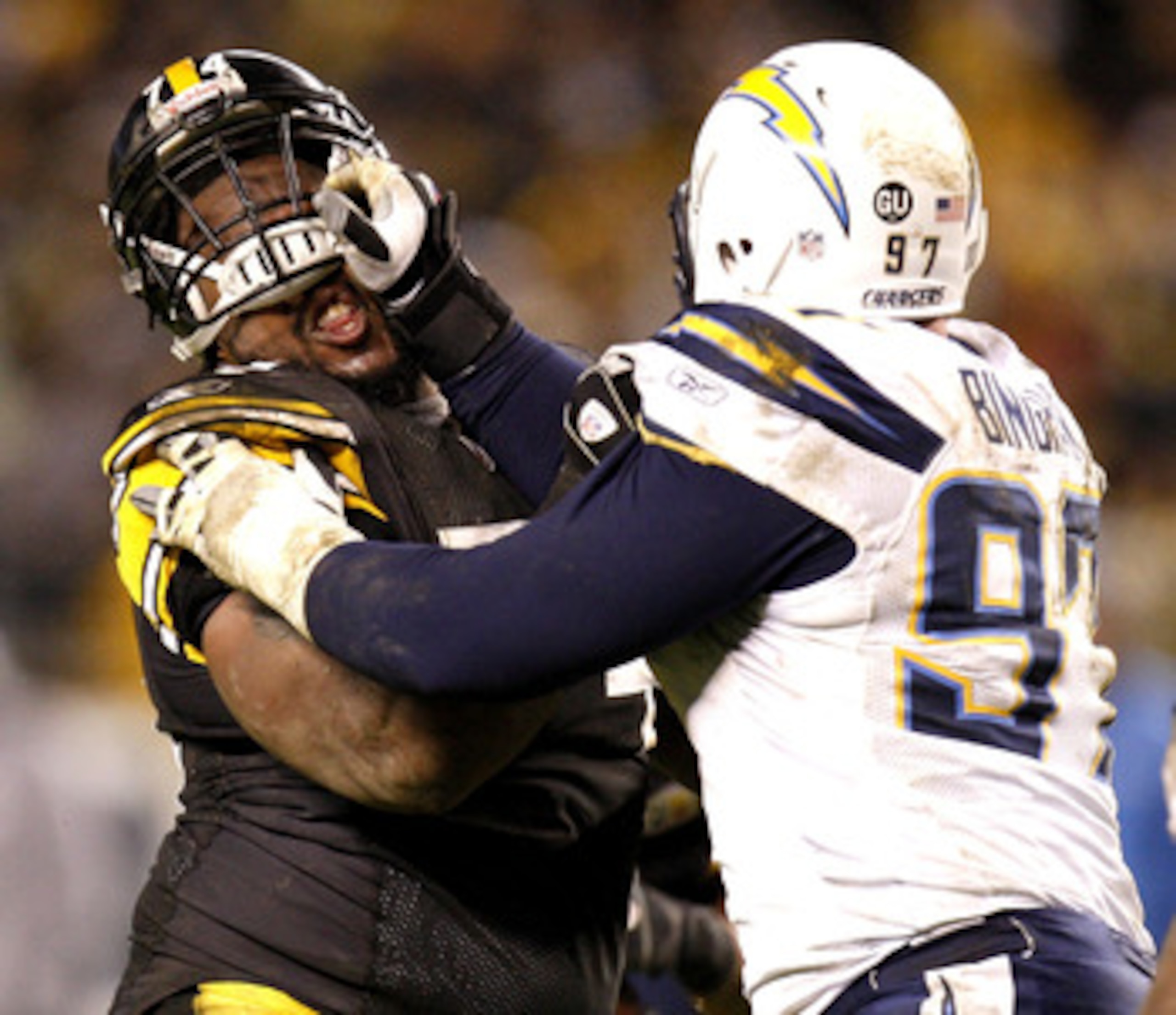 PITTSBURGH - NOVEMBER 16:  Willie Colon #74 of the Pittsburgh Steelers has his helmet pushed up while blocking by Ryon Bingham #97 of the San Diego Chargers on November 16, 2008 at Heinz Field in Pittsburgh, Pennsylvania. Pittsburgh won the game 11-10. (P