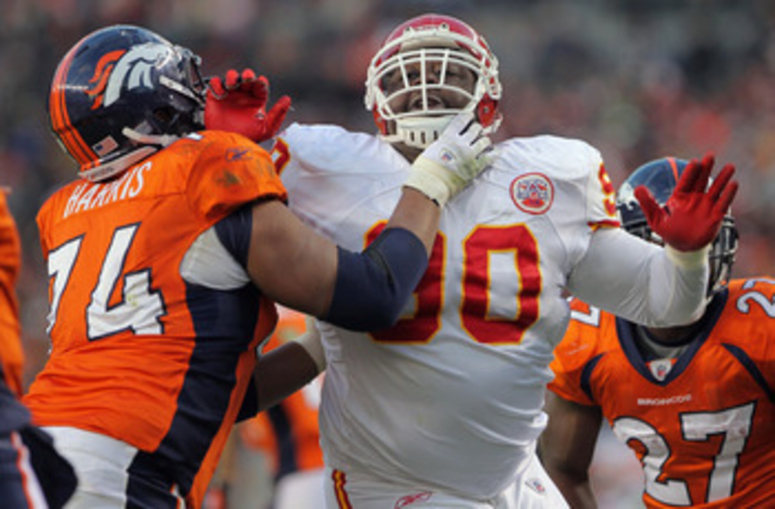 DENVER - NOVEMBER 14:  Defensive tackle Shaun Smith #90 of the Kansas City Chiefs rushes quarterback Kyle Orton against the protection of offensive lineman Ryan Harris #74 of the Denver Bronco at INVESCO Field at Mile High on November 14, 2010 in Denver, 