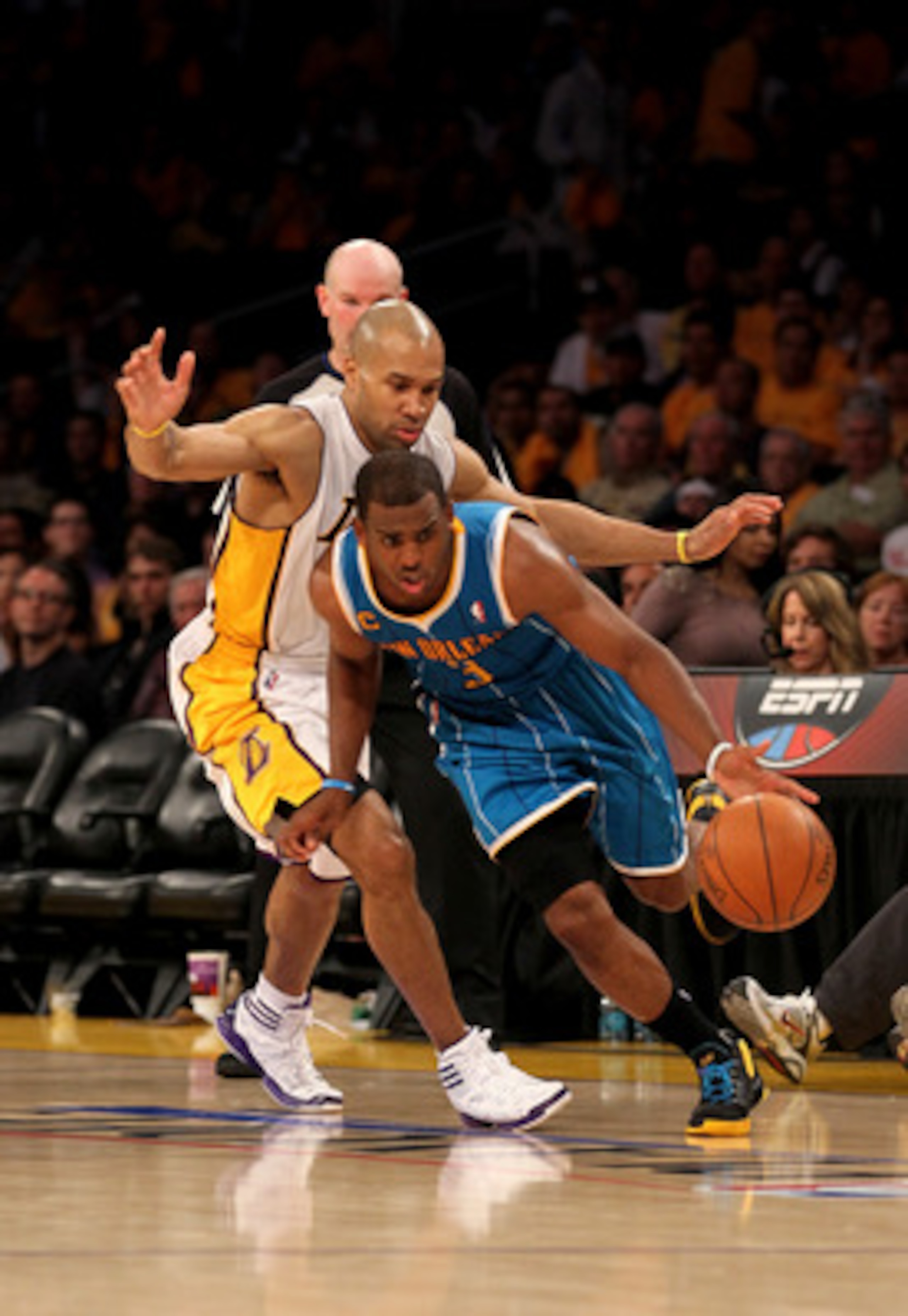 LOS ANGELES, CA - APRIL 17:  Chris Paul #3 of  the New Orleans Hornets gets past Derek Fisher #2 of the Los Angeles Lakers in Game One of the Western Conference Quarterfinals in the 2011 NBA Playoffs on April 17, 2011 at Staples Center in Los Angeles, Cal