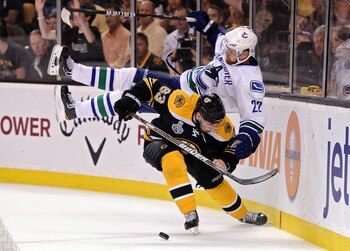 BOSTON, MA - JUNE 08: Brad Marchand #63 of the Boston Bruins dodges Daniel Sedin #22 of the Vancouver Canucks during Game Four of the 2011 NHL Stanley Cup Final at TD Garden on June 8, 2011 in Boston, Massachusetts. (Photo by Harry How/Getty Images) BOSTON, MA - JUNE 08: Brad Marchand #63 of the Boston Bruins dodges Daniel Sedin #22 of the Vancouver Canucks during Game Four of the 2011 NHL Stanley Cup Final at TD Garden on June 8, 2011 in Boston, Massachusetts. (Photo by Harry How/Getty Images)