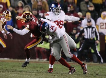 LANDOVER, MD - DECEMBER 21:  Hunter Smith #3 of the Washington Redskins is tackled by Mathias Kiwanuka #94 of the New York Giants on a fake field goal during their game on December 21, 2009 at Fedex Field in Landover, Maryland.  (Photo by Al Bello/Getty I