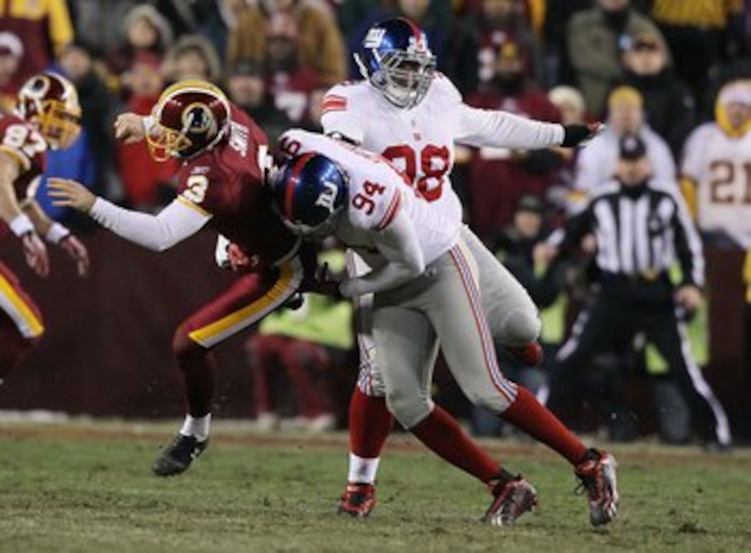LANDOVER, MD - DECEMBER 21:  Hunter Smith #3 of the Washington Redskins is tackled by Mathias Kiwanuka #94 of the New York Giants on a fake field goal during their game on December 21, 2009 at Fedex Field in Landover, Maryland.  (Photo by Al Bello/Getty I