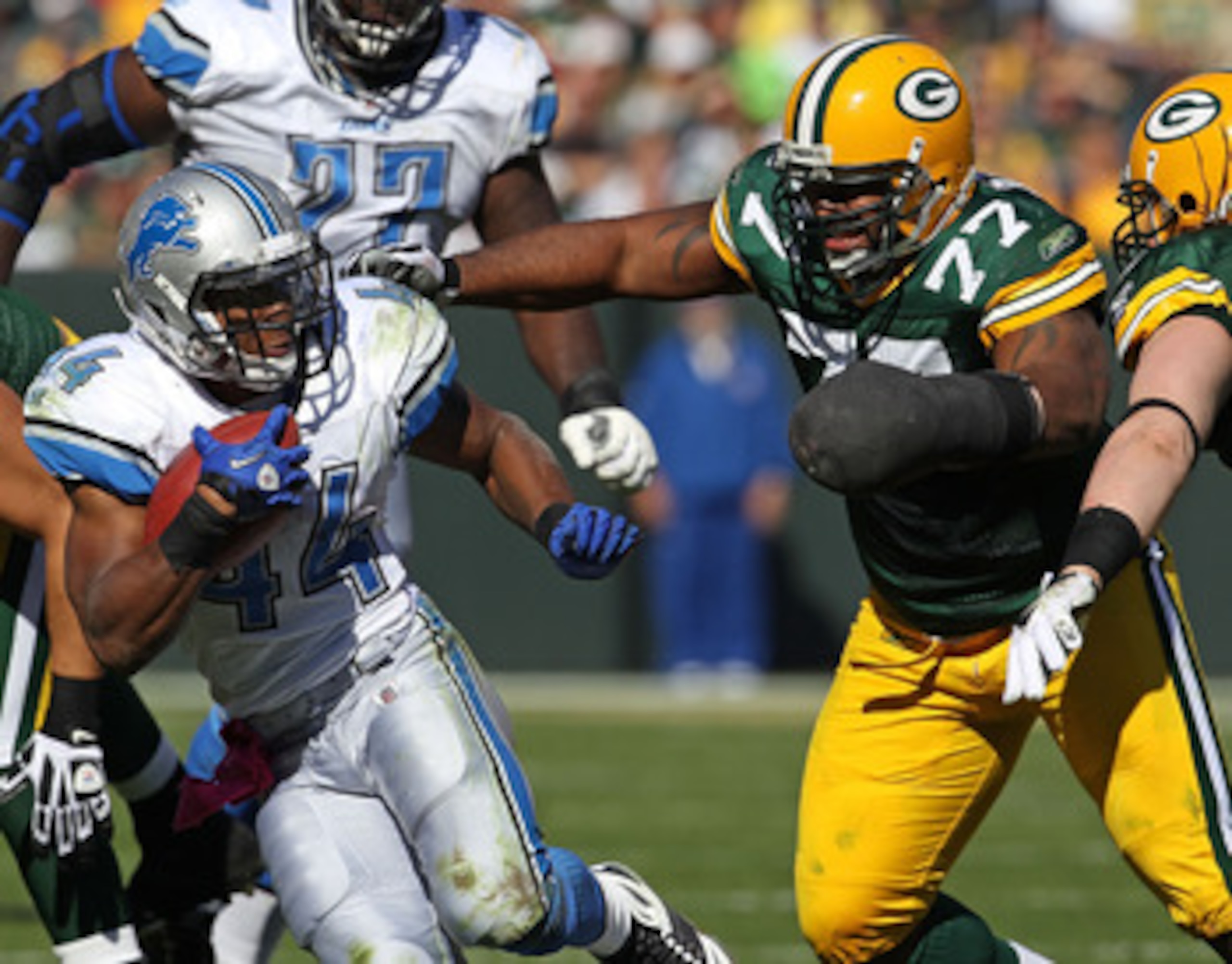 GREEN BAY, WI - OCTOBER 03: Jahvid Best #44 of the Detroit Lions moves to avoid Cullen Jenkins #77 and A.J. Hawk #50 of the Green Bay Packers at Lambeau Field on October 3, 2010 in Green Bay, Wisconsin. The Packers defeated the Lions 28-26. (Photo by Jona