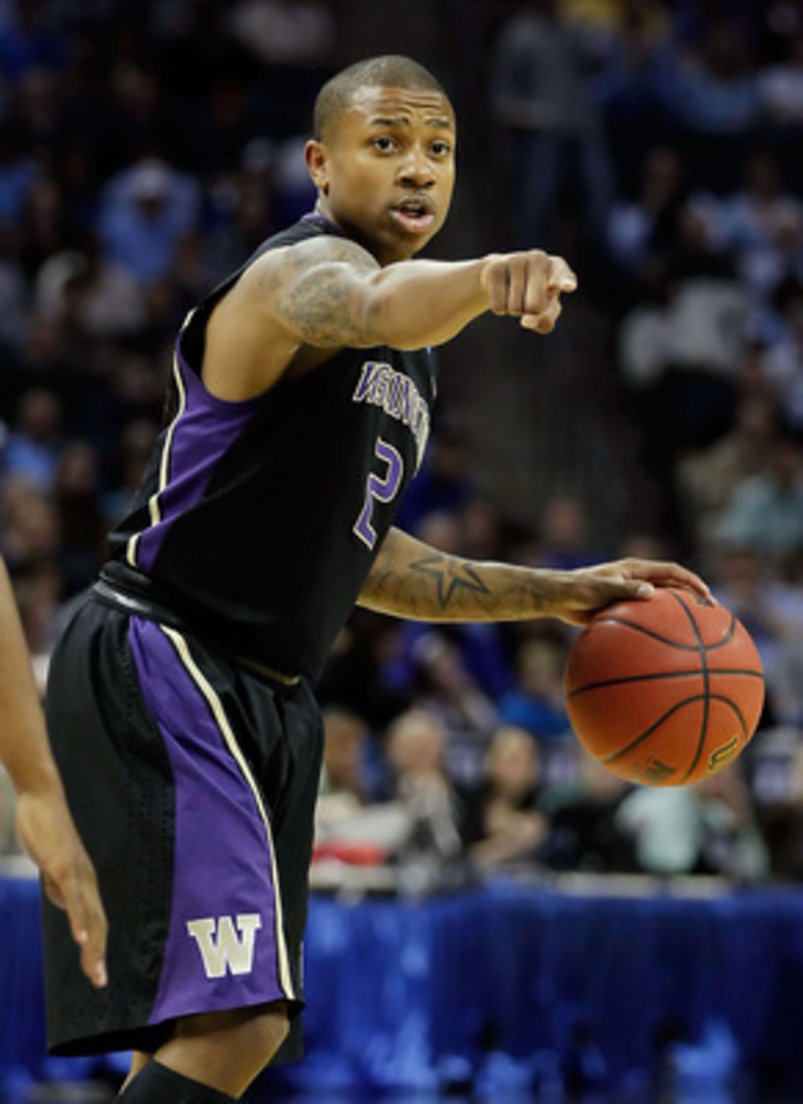 CHARLOTTE, NC - MARCH 20:  Isaiah Thomas #2 of the Washington Huskies points in the first half while taking on the North Carolina Tar Heels during the third round of the 2011 NCAA men's basketball tournament at Time Warner Cable Arena on March 20, 2011 in
