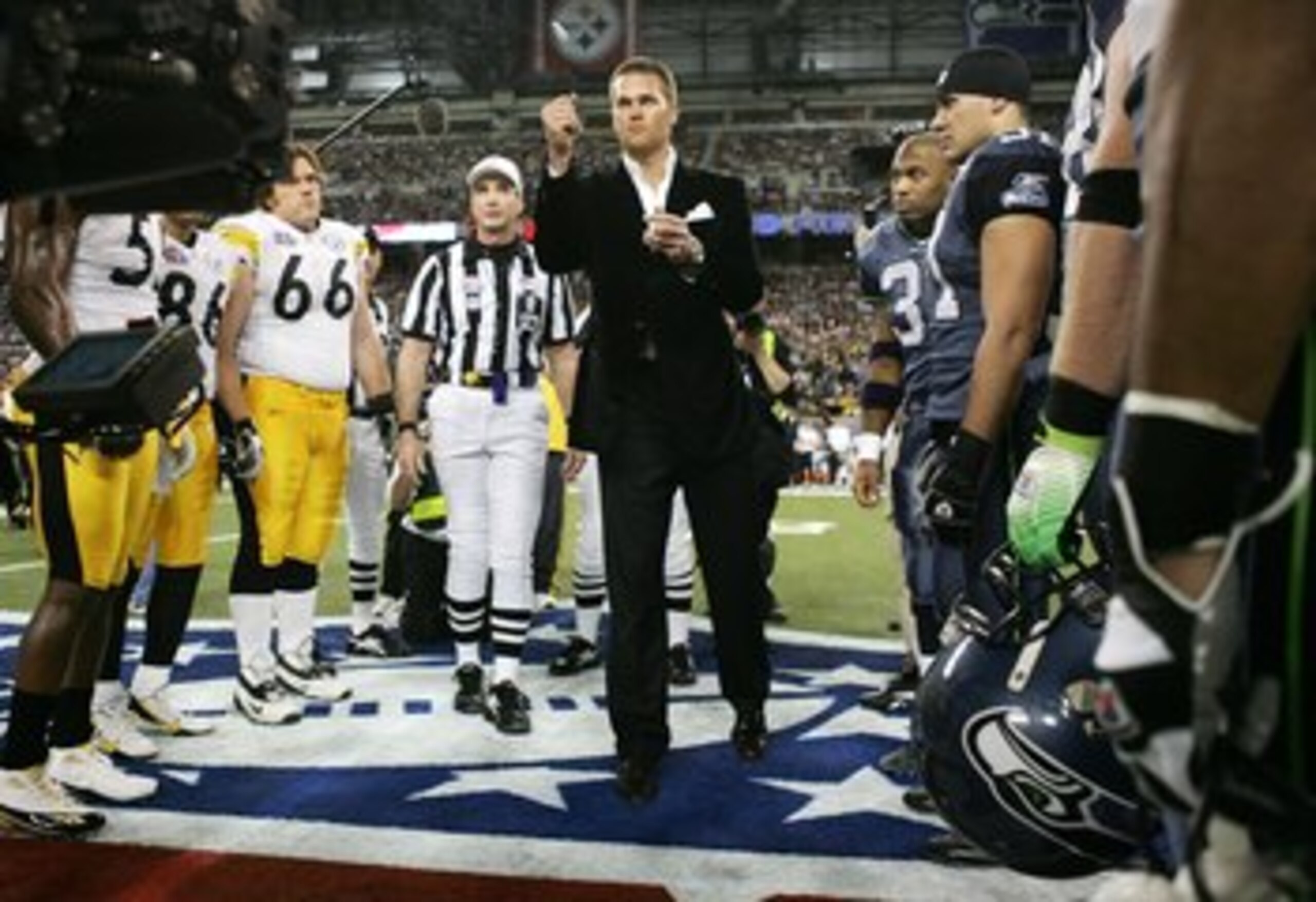 DETROIT - FEBRUARY 05:  Super Bowl MVP and New England Patriots quarterback Tom Brady performs the coin toss before the start of Super Bowl XL between the Pittsburgh Steelers and Seattle Seahawks at Ford Field on February 5, 2006 in Detroit, Michigan.  (P