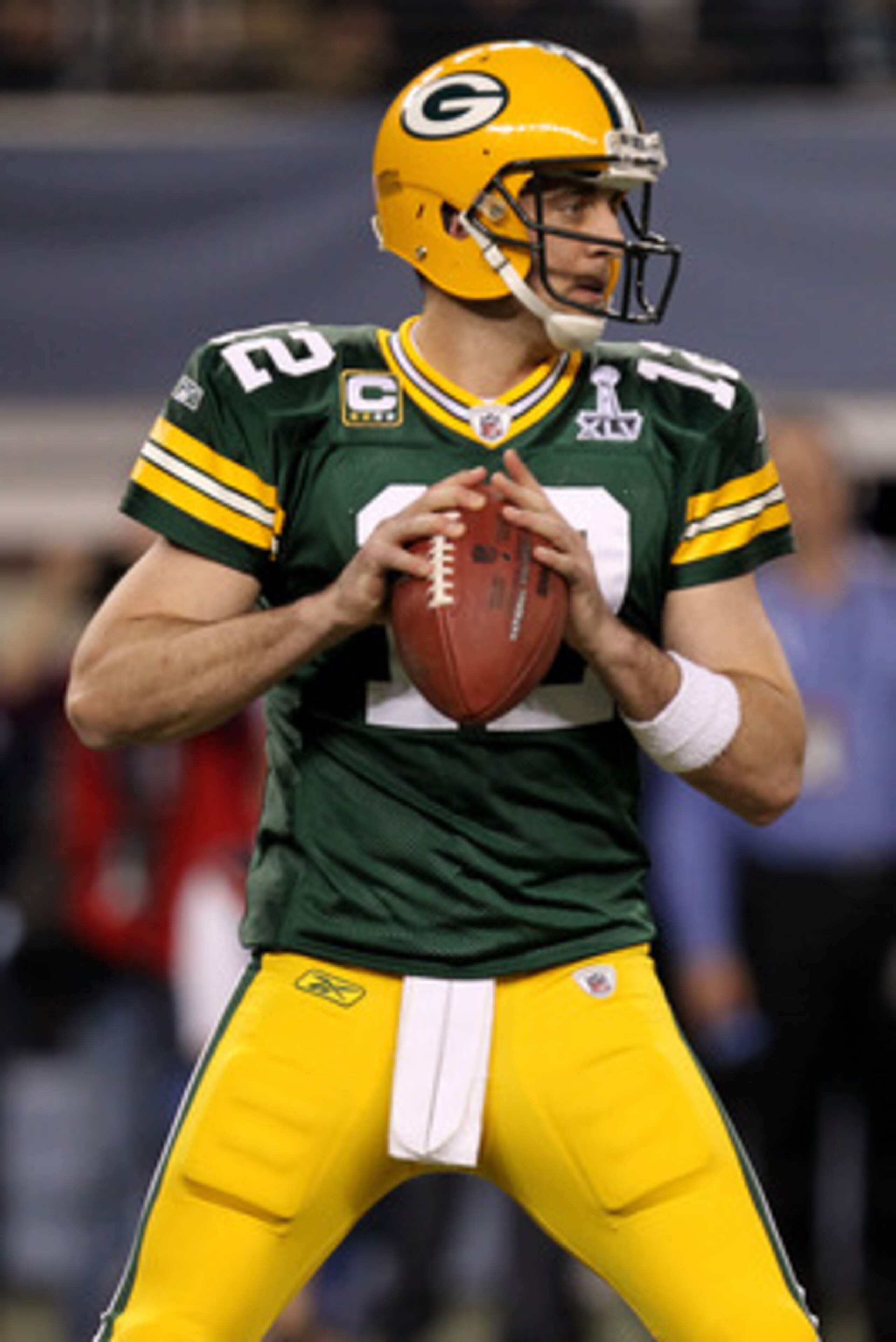 ARLINGTON, TX - FEBRUARY 06:  Aaron Rodgers #12 of the Green Bay Packers drops back against the Pittsburgh Steelers during the first quarter of Super Bowl XLV at Cowboys Stadium on February 6, 2011 in Arlington, Texas.  (Photo by Ronald Martinez/Getty Ima