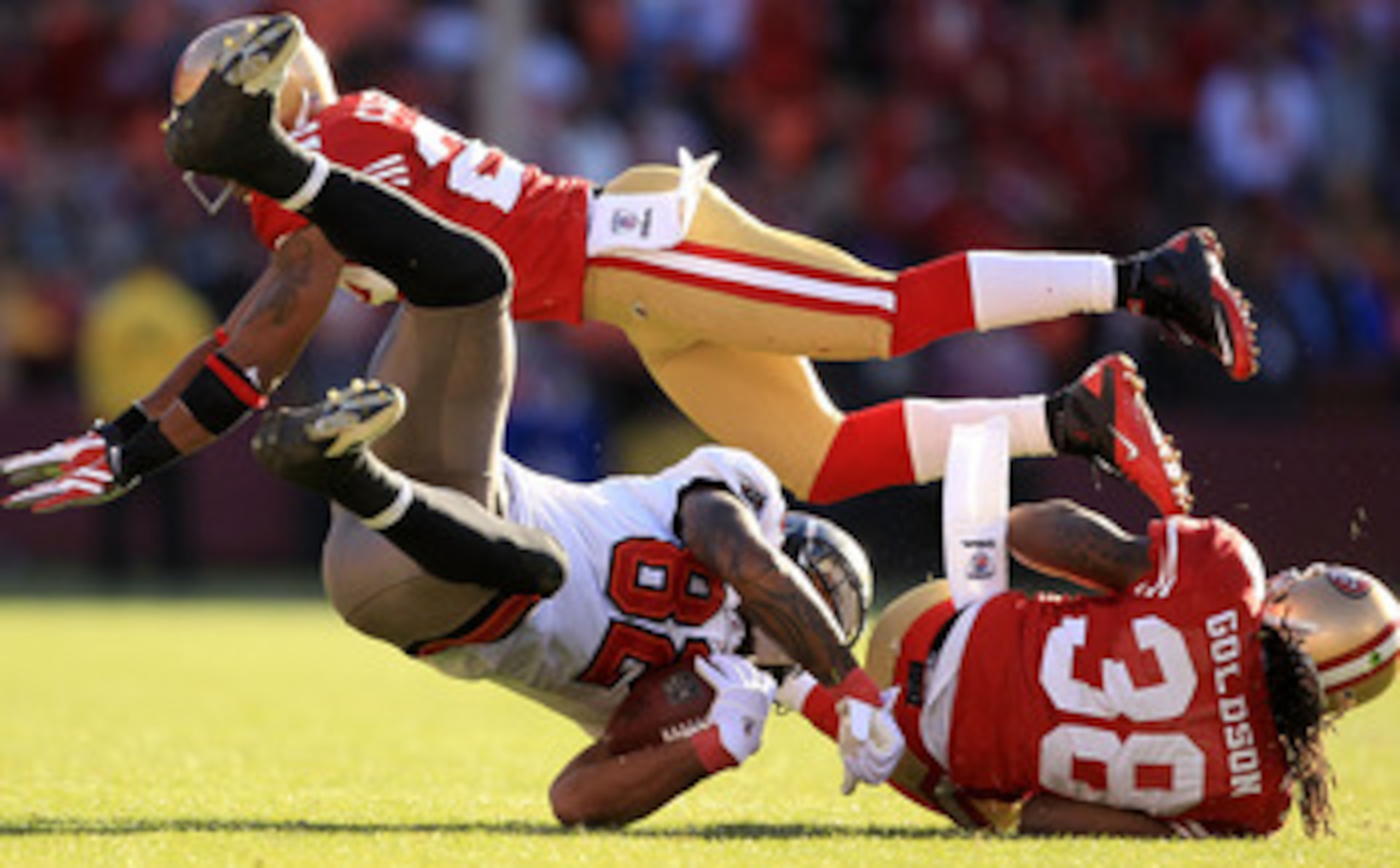 SAN FRANCISCO - NOVEMBER 21: Kellen Winslow #82 of the Tampa Bay Buccaneers is hit by Dashon Goldson #38 and Nate Clements #22 of the San Francisco 49ers at Candlestick Park on November 21, 2010 in San Francisco, California.  (Photo by Ezra Shaw/Getty Ima