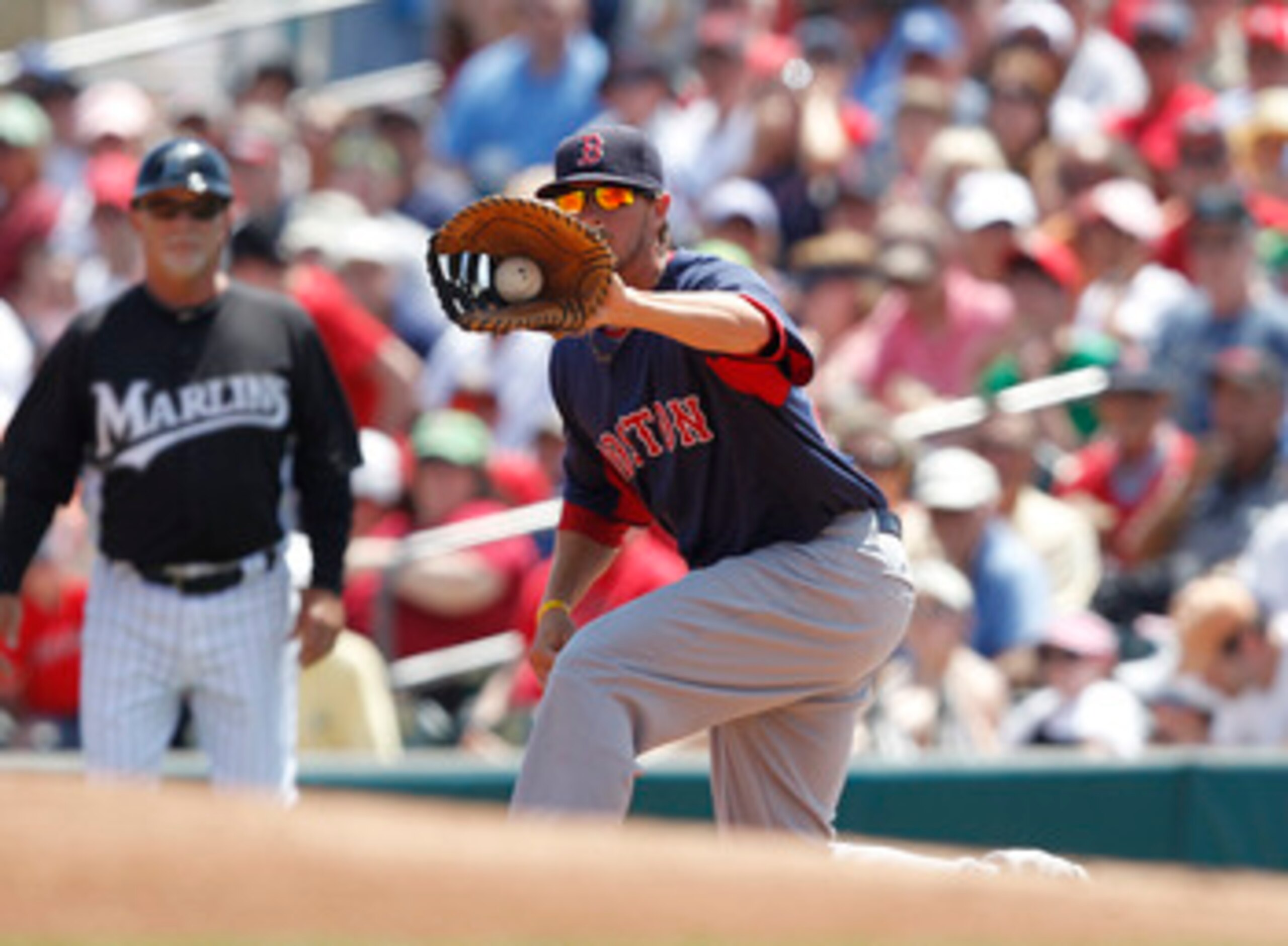 JUPITER, FL - MARCH 24: Drew Sutton #70 catches the ball from Jed Lowrie #12 (not pictured) of the Boston Red Sox to get Omar Infante #13 (not pictured) of the Florida Marlins out in the first inning at Roger Dean Stadium on March 24, 2011 in Jupiter, Flo