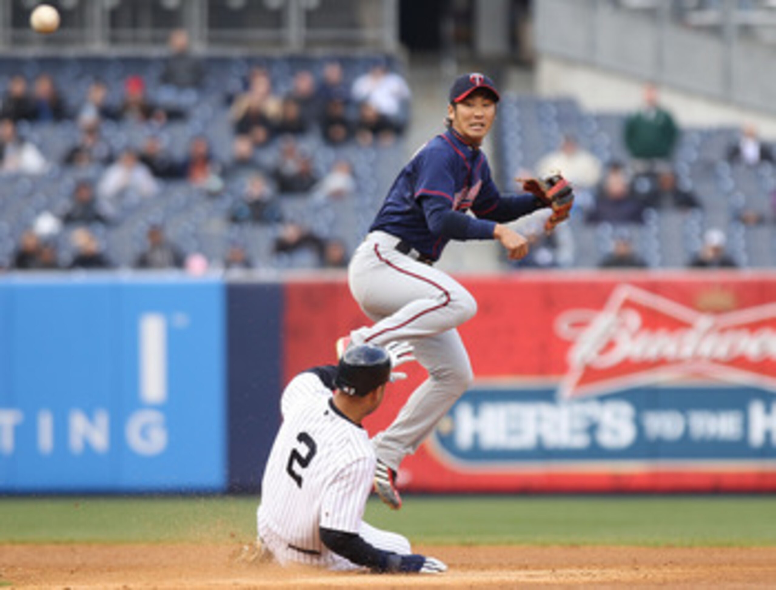 NEW YORK, NY - APRIL 07:  Tsuyoshi Nishioka #1 of the Minnesota Twins fails to turn the double play over Derek Jeter #2 of the New York Yankees at Yankee Stadium on April 7, 2011 in the Bronx borough of New York City.  (Photo by Nick Laham/Getty Images)