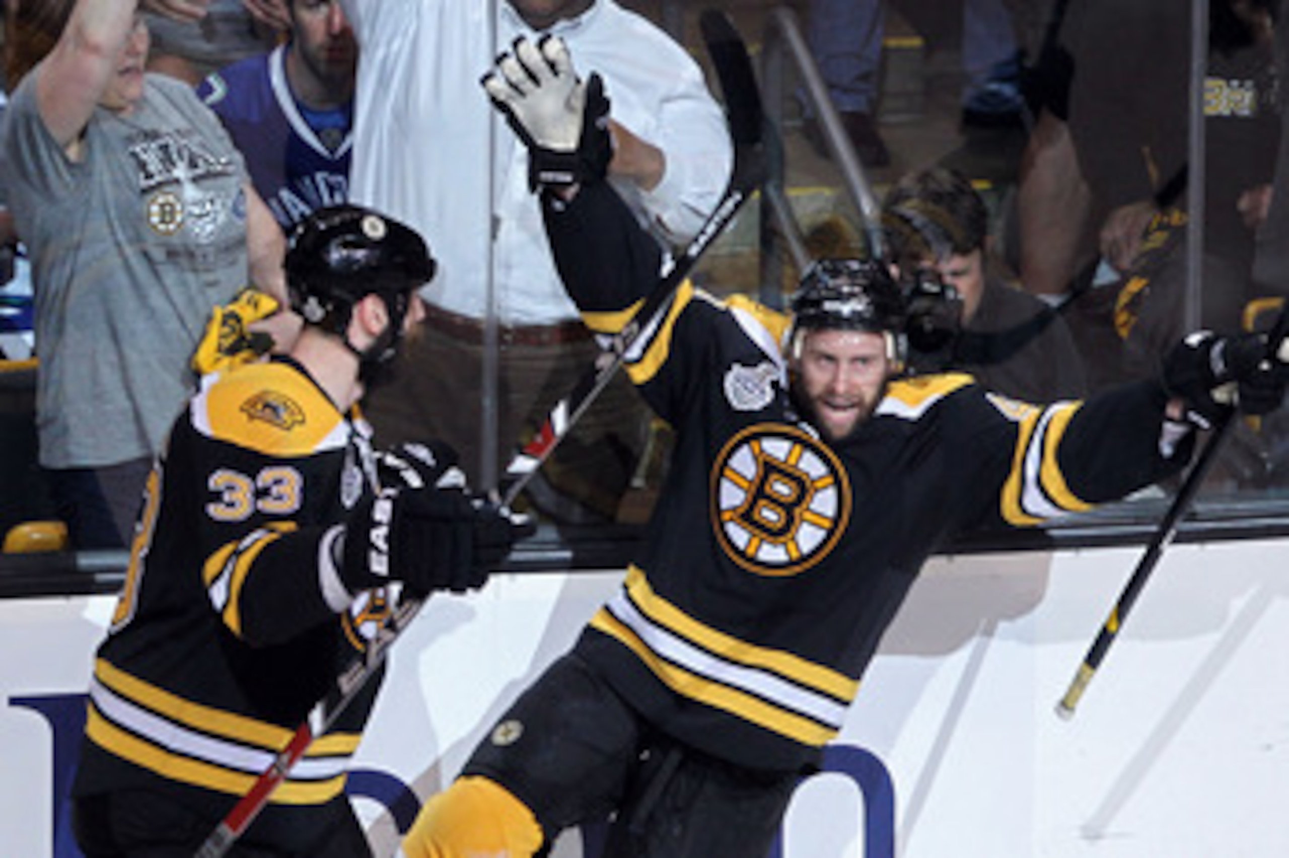 BOSTON, MA - JUNE 08:  Rich Peverley #49 of the Boston Bruins celebrates with his teammate Zdeno Chara #33 after he scored a goal in the first period against Roberto Luongo #1 of the Vancouver Canucks during Game Four of the 2011 NHL Stanley Cup Final at