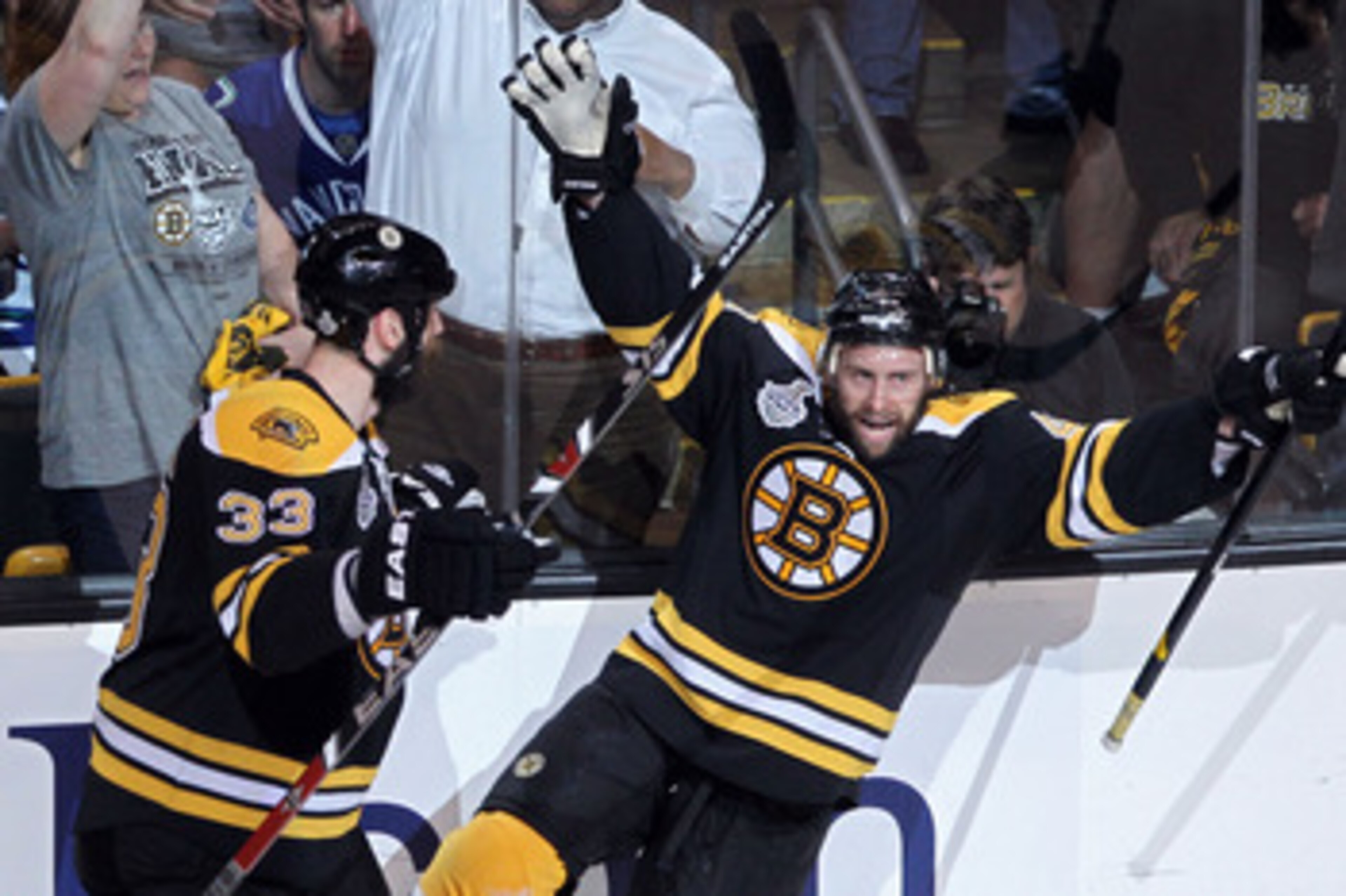 BOSTON, MA - JUNE 08:  Rich Peverley #49 of the Boston Bruins celebrates with his teammate Zdeno Chara #33 after he scored a goal in the first period against Roberto Luongo #1 of the Vancouver Canucks during Game Four of the 2011 NHL Stanley Cup Final at