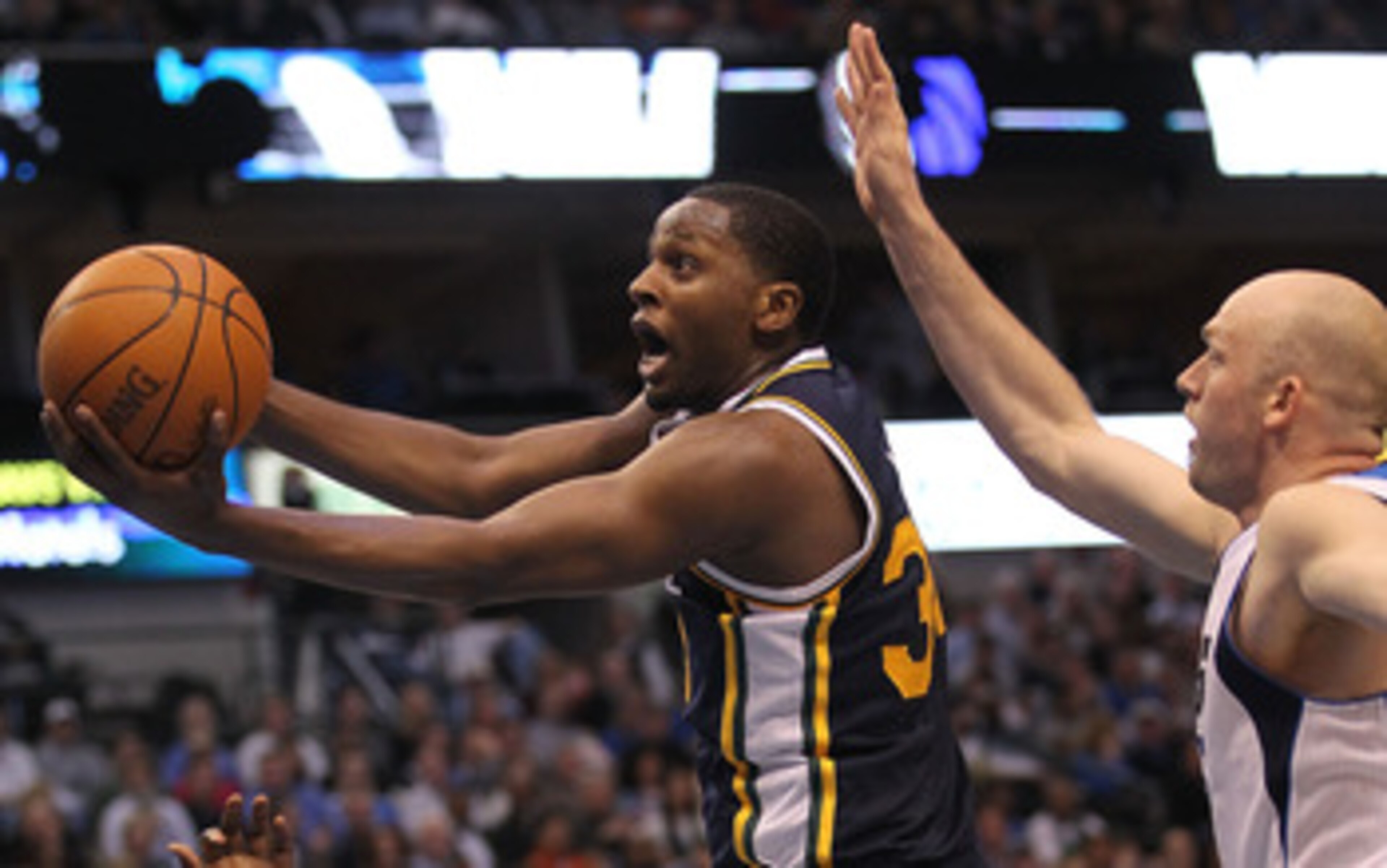 DALLAS, TX - FEBRUARY 23:  Forward C.J. Miles #34 of the Utah Jazz takes a shot against Brian Cardinal #35 of the Dallas Mavericks at American Airlines Center on February 23, 2011 in Dallas, Texas.  NOTE TO USER: User expressly acknowledges and agrees tha