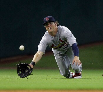 HOUSTON - JUNE 08:  Center fielder Colby Rasmus  #28 of the St. Louis Cardinals dives but comes up short on a sinking line drive hit by J.R. Towles #46 of the Houston Astros at Minute Maid Park on June 8, 2011 in Houston, Texas.  (Photo by Bob Levey/Getty