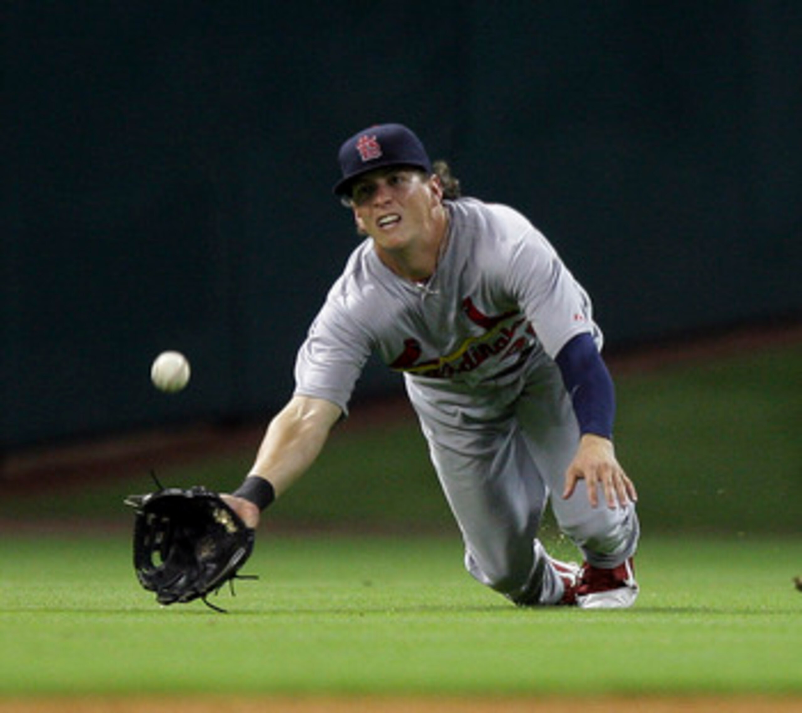 HOUSTON - JUNE 08:  Center fielder Colby Rasmus  #28 of the St. Louis Cardinals dives but comes up short on a sinking line drive hit by J.R. Towles #46 of the Houston Astros at Minute Maid Park on June 8, 2011 in Houston, Texas.  (Photo by Bob Levey/Getty