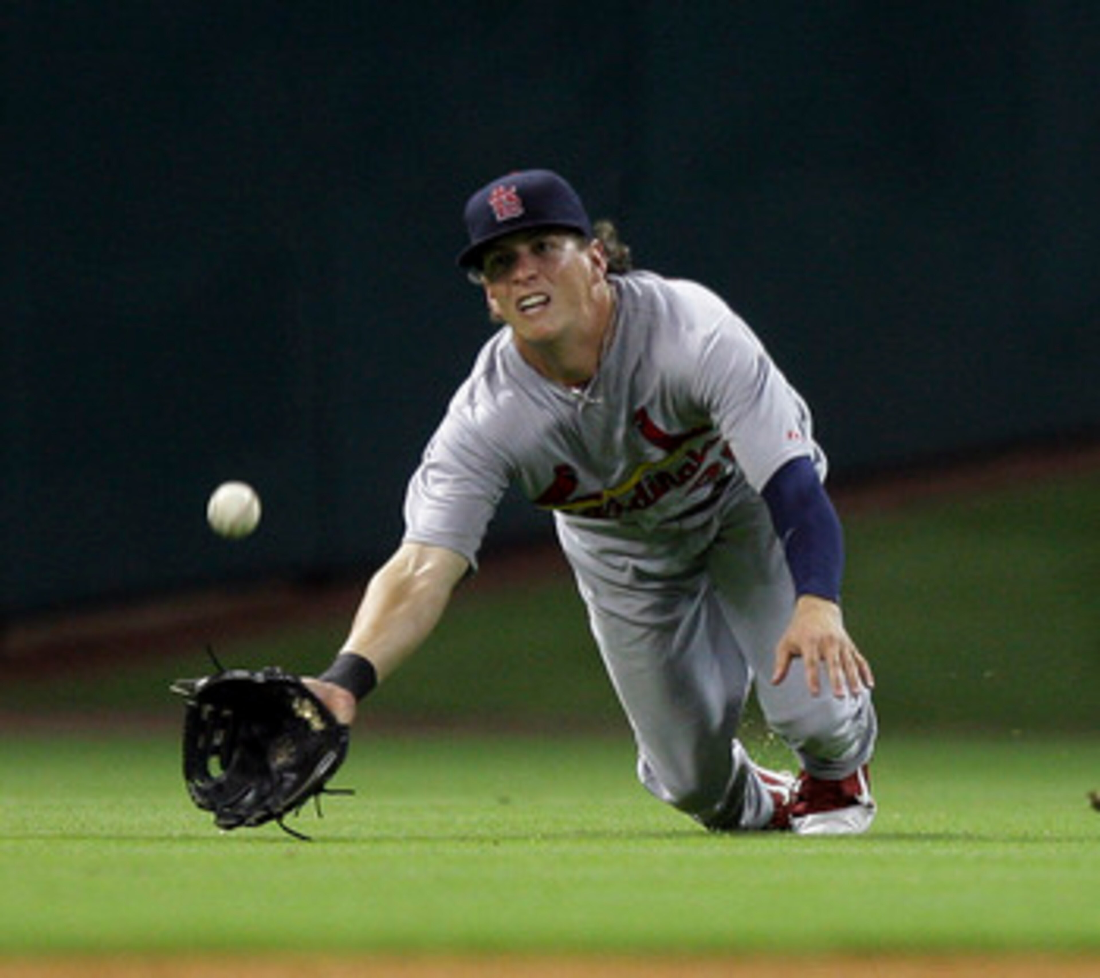 HOUSTON - JUNE 08:  Center fielder Colby Rasmus  #28 of the St. Louis Cardinals dives but comes up short on a sinking line drive hit by J.R. Towles #46 of the Houston Astros at Minute Maid Park on June 8, 2011 in Houston, Texas.  (Photo by Bob Levey/Getty