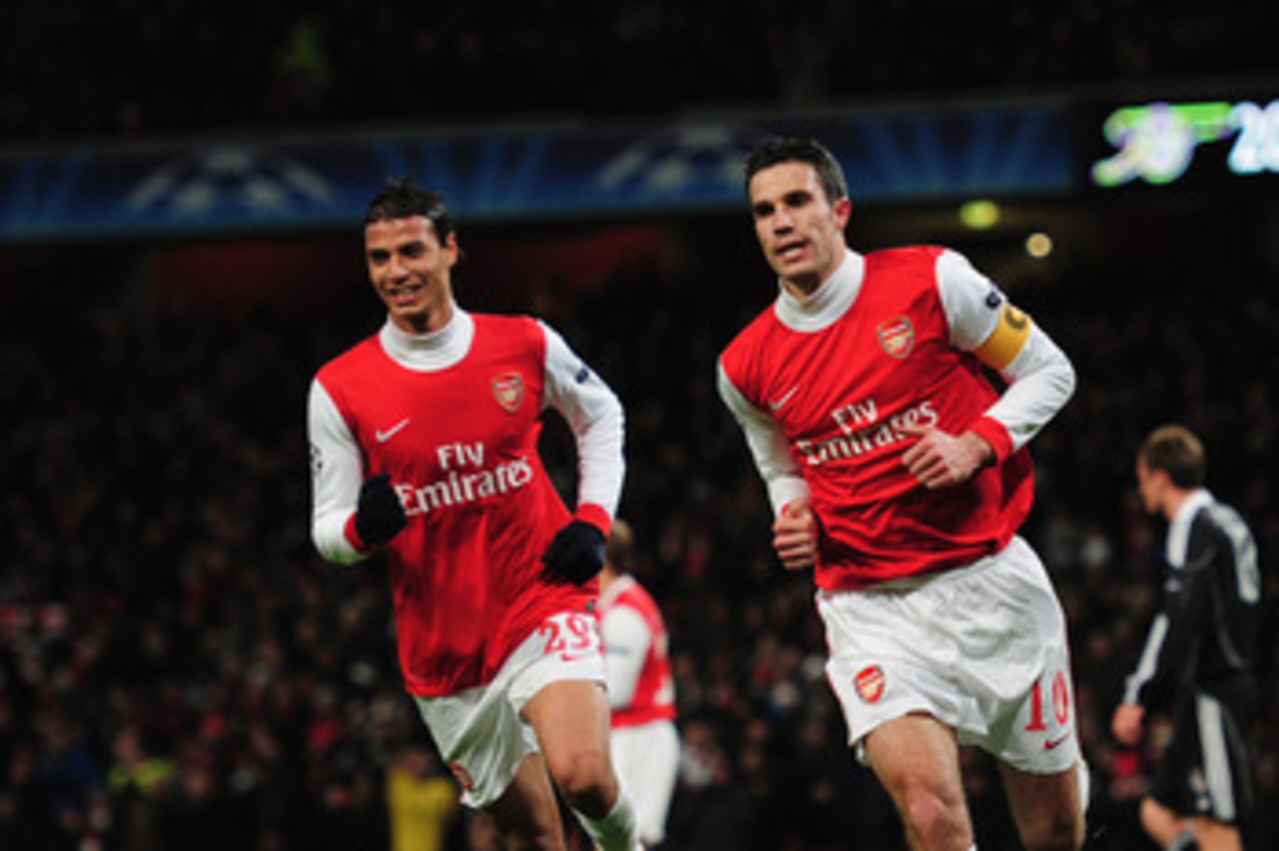 LONDON, ENGLAND - DECEMBER 08:  Robin van Persie of Arsenal celebrates with Marouane Chamakh (L) as he scores their first goal from the penalty spot during the UEFA Champions League Group H match between Arsenal and FK Partizan Belgrade at the Emirates St