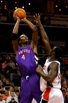 CHARLOTTE, NC - DECEMBER 10:  Chris Bosh #4 of the Toronto Raptors shoots over Emeka Okafor #50 of the Charlotte Bobcats during their game on December 10, 2005 at the Charlotte Bobcats Arena in Charlotte, North Carolina. The Raptors defeated the Bobcats 1