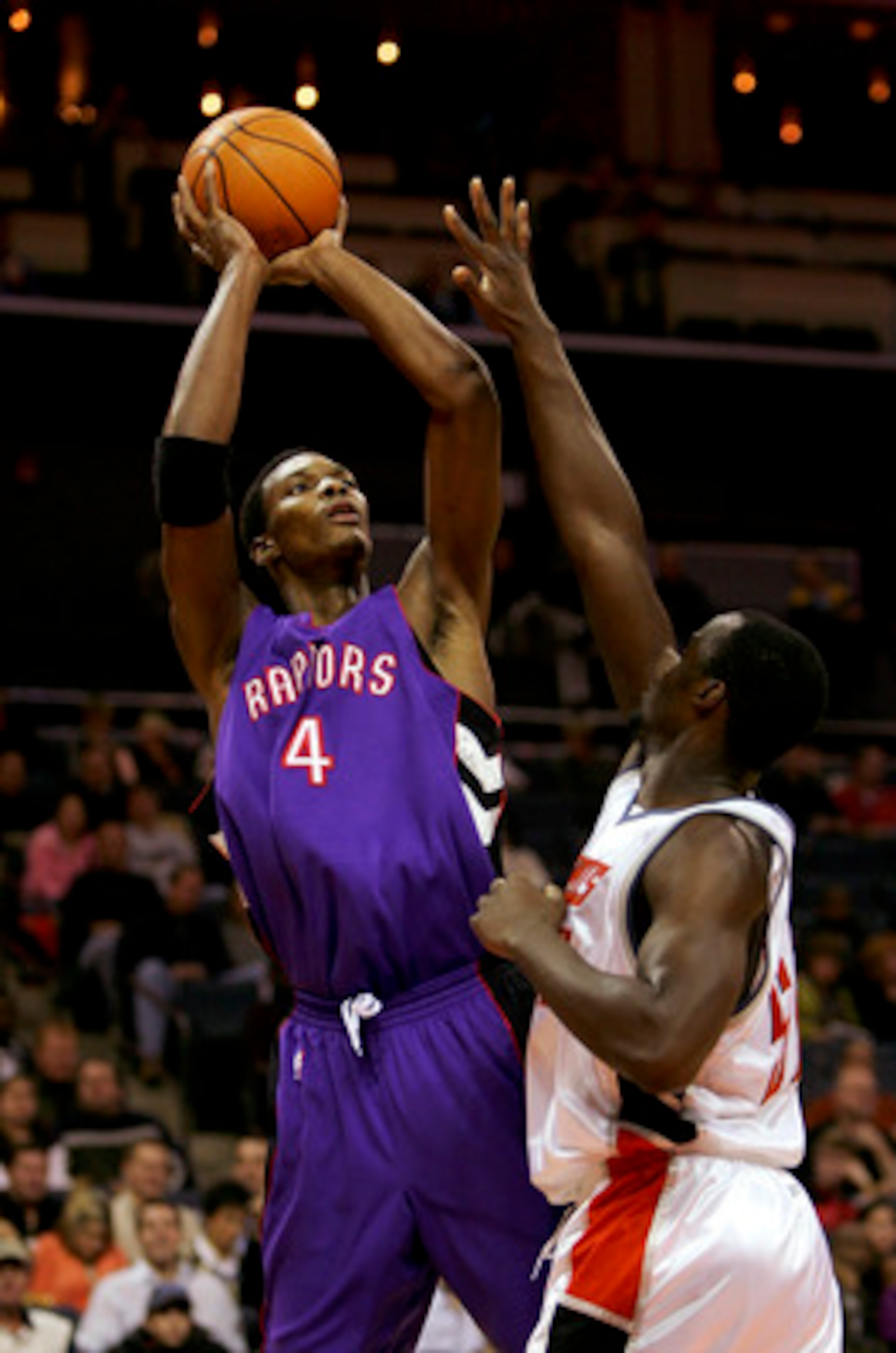 CHARLOTTE, NC - DECEMBER 10:  Chris Bosh #4 of the Toronto Raptors shoots over Emeka Okafor #50 of the Charlotte Bobcats during their game on December 10, 2005 at the Charlotte Bobcats Arena in Charlotte, North Carolina. The Raptors defeated the Bobcats 1