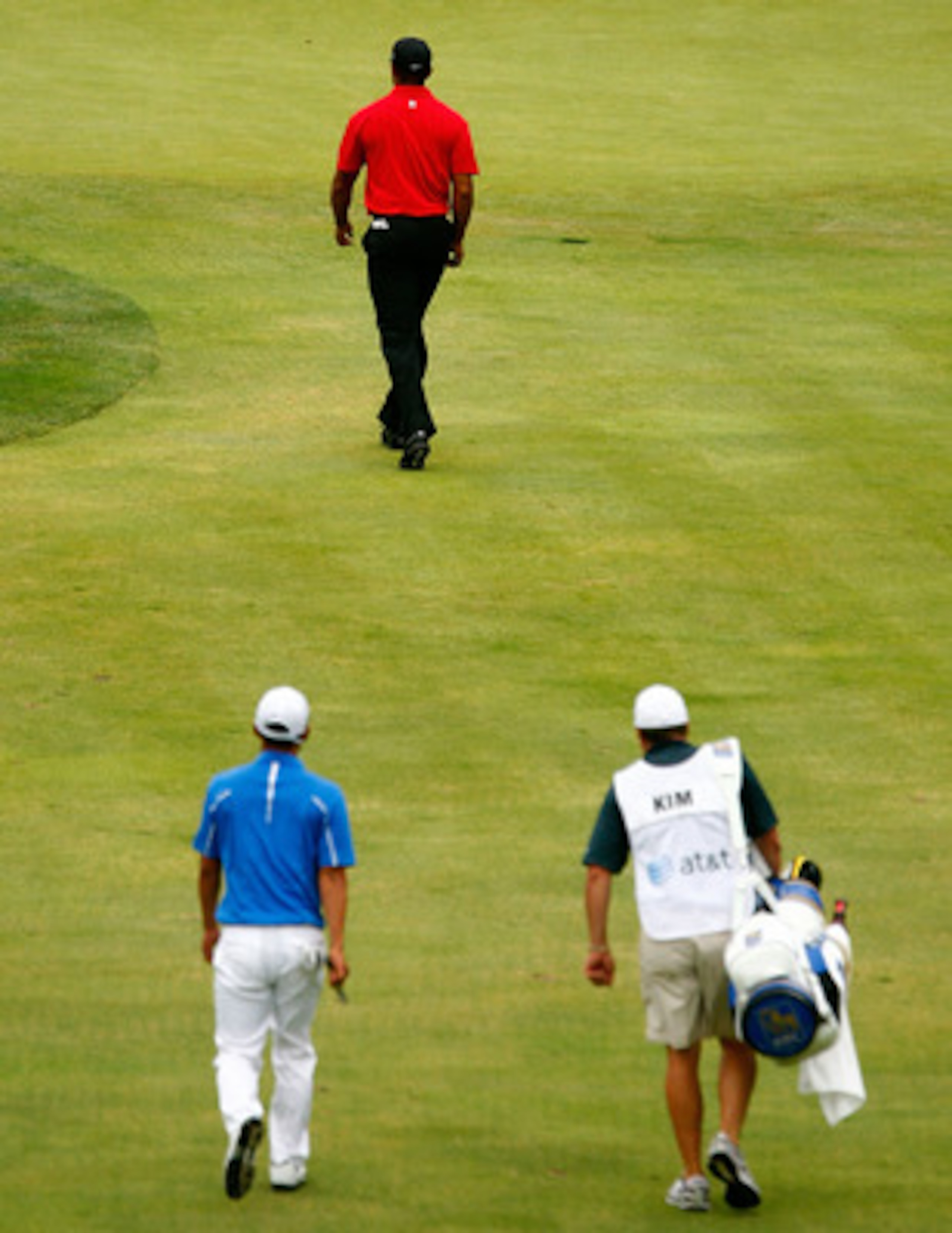 BETHESDA, MD - JULY 05:  Tiger Woods walks to the 17th green ahead of Anthony Kim and his caddie  during the final round of the AT&T National at the Congressional Country Club on July 5, 2009 in Bethesda, Maryland.  (Photo by Scott Halleran/Getty Images)