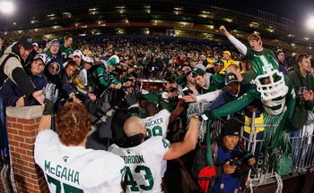 ANN ARBOR, MI - OCTOBER 25:  (L-R) Jared McGaha #75, Eric Gordon #43, and Chris L. Rucker #29 of the Michigan State Spartans celebrate with the fans after the game against the Michigan Wolverines on October 25, 2008 at Michigan Stadium in Ann Arbor, Michi