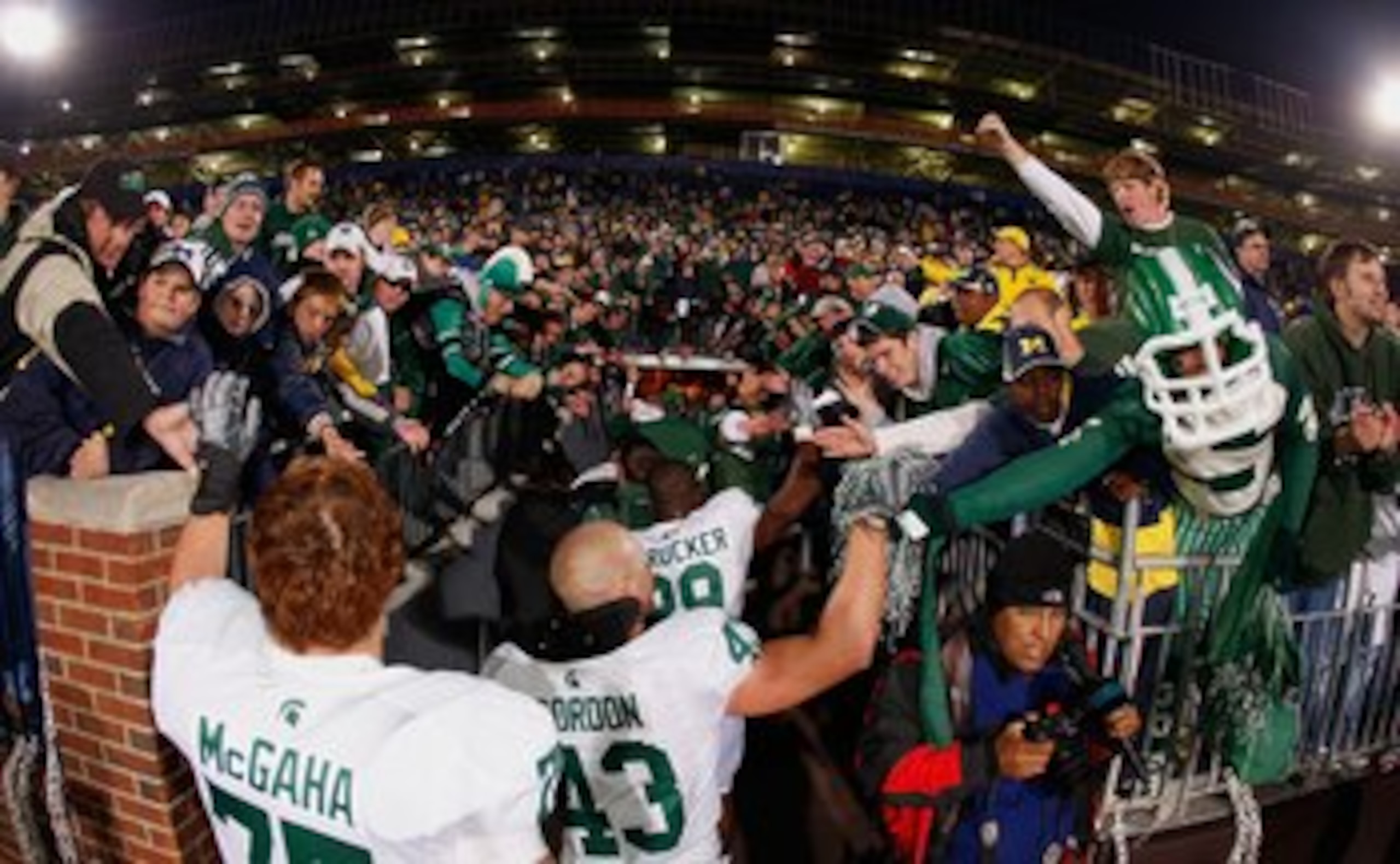 ANN ARBOR, MI - OCTOBER 25: (L-R) Jared McGaha #75, Eric Gordon #43, and Chris L. Rucker #29 of the Michigan State Spartans celebrate with the fans after the game against the Michigan Wolverines on October 25, 2008 at Michigan Stadium in Ann Arbor, Michi ANN ARBOR, MI - OCTOBER 25: (L-R) Jared McGaha #75, Eric Gordon #43, and Chris L. Rucker #29 of the Michigan State Spartans celebrate with the fans after the game against the Michigan Wolverines on October 25, 2008 at Michigan Stadium in Ann Arbor, Michi