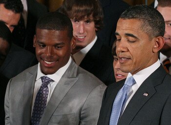 WASHINGTON, DC - JUNE 08: President Barack Obama (R) holds an Auburn Tigers helmet given to him by members of the 2011 BCS National Champion Auburn University football team including Heisman Trophy winner Cameron 'Cam' Newton in the East Room at the White