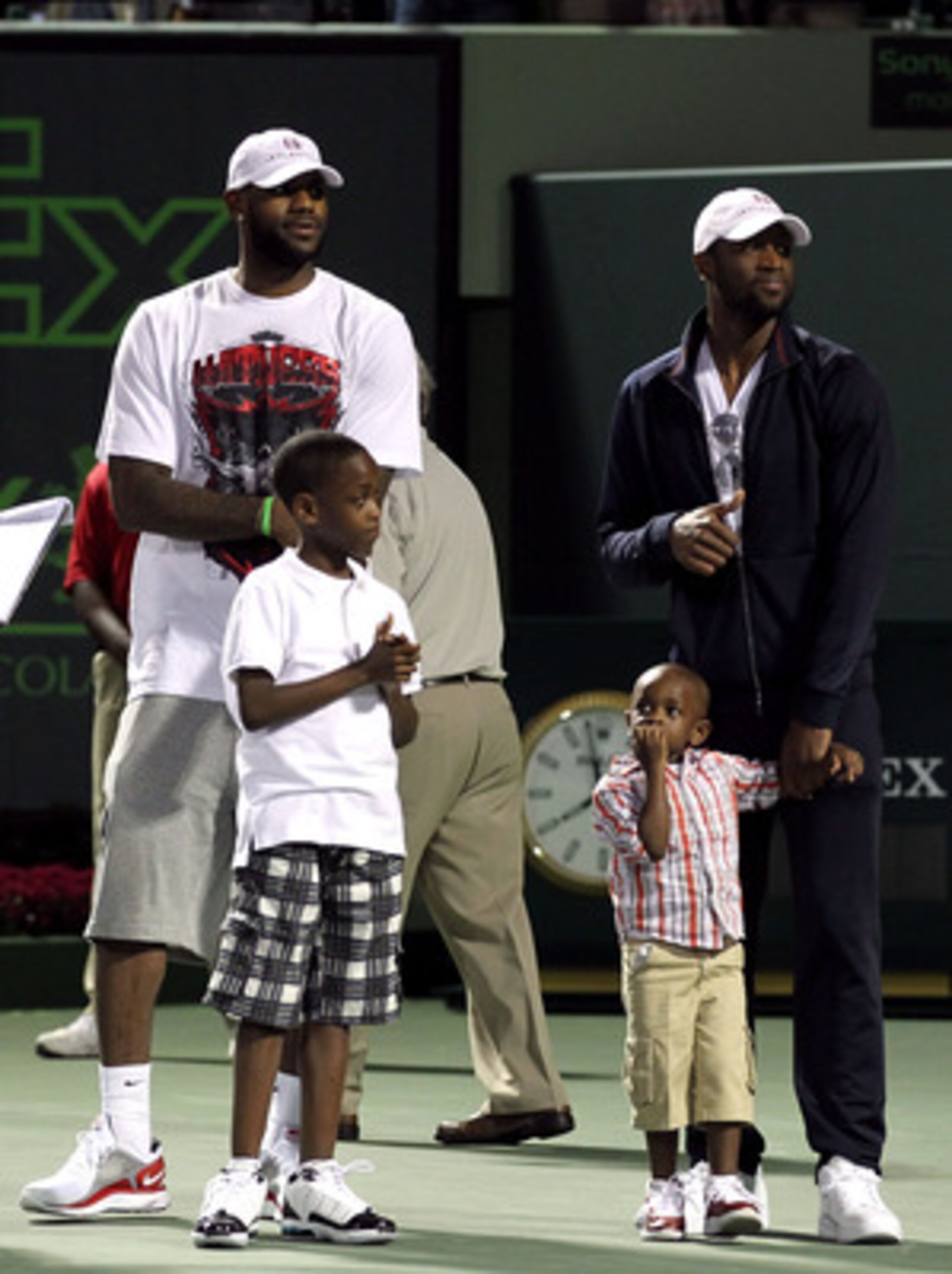 KEY BISCAYNE, FL - MARCH 26:  LeBron James (L) and Dwyane Wade of the NBA Miami Heat stand the court with Wade's sons Zaire (L) and Zion (holding Wade's hand) during the Sony Ericsson Open at Crandon Park Tennis Center on March 26, 2011 in Key Biscayne, F