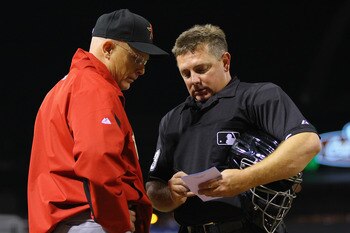 ST. LOUIS, MO - MAY 18: Brad Mills #2 of the Houston Astros discusses his line-up changes against the St. Louis Cardinals with umpire Greg Gibson #53 at Busch Stadium on May 18, 2011 in St. Louis, Missouri.  (Photo by Dilip Vishwanat/Getty Images)
