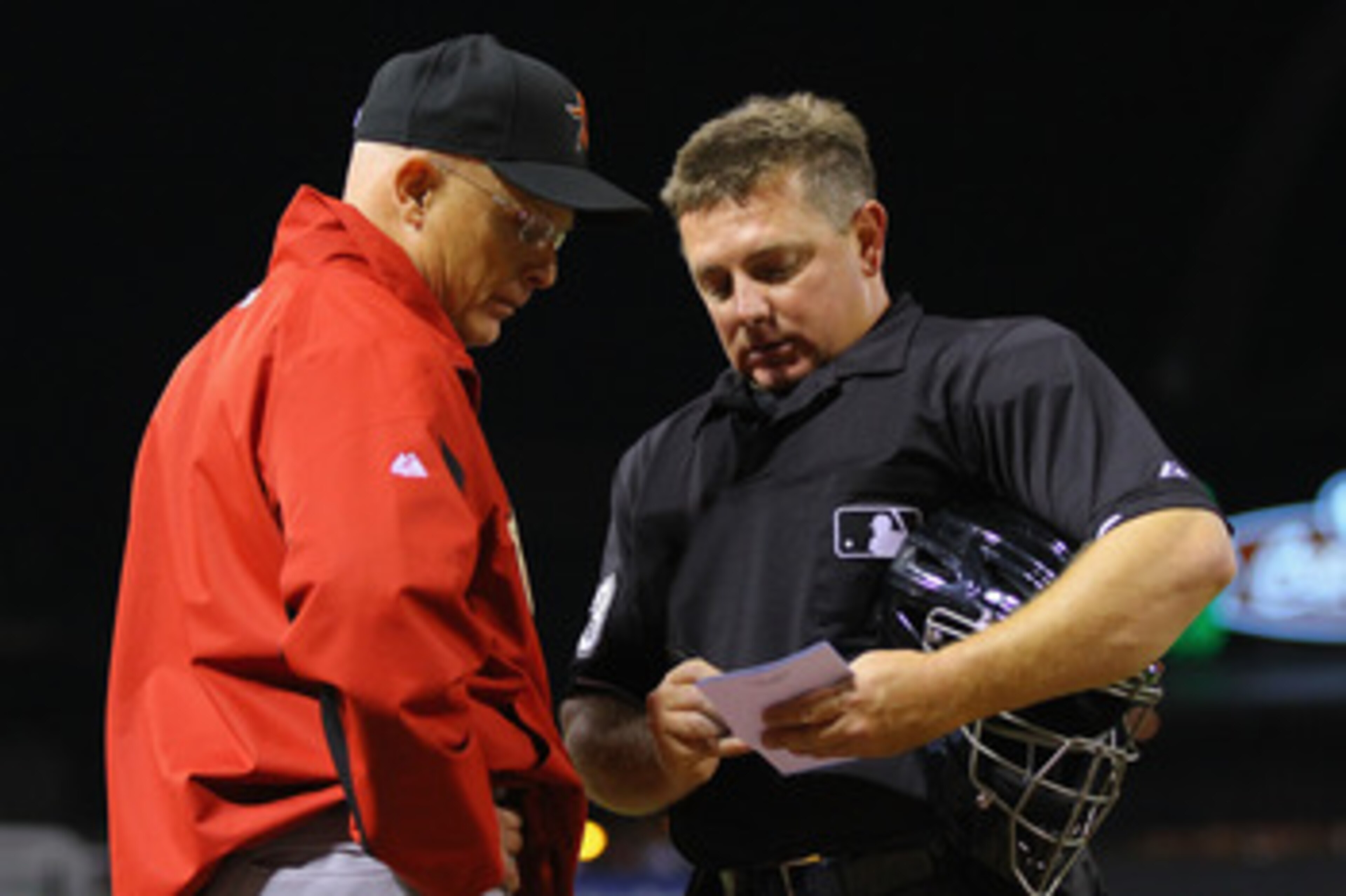 ST. LOUIS, MO - MAY 18: Brad Mills #2 of the Houston Astros discusses his line-up changes against the St. Louis Cardinals with umpire Greg Gibson #53 at Busch Stadium on May 18, 2011 in St. Louis, Missouri.  (Photo by Dilip Vishwanat/Getty Images)