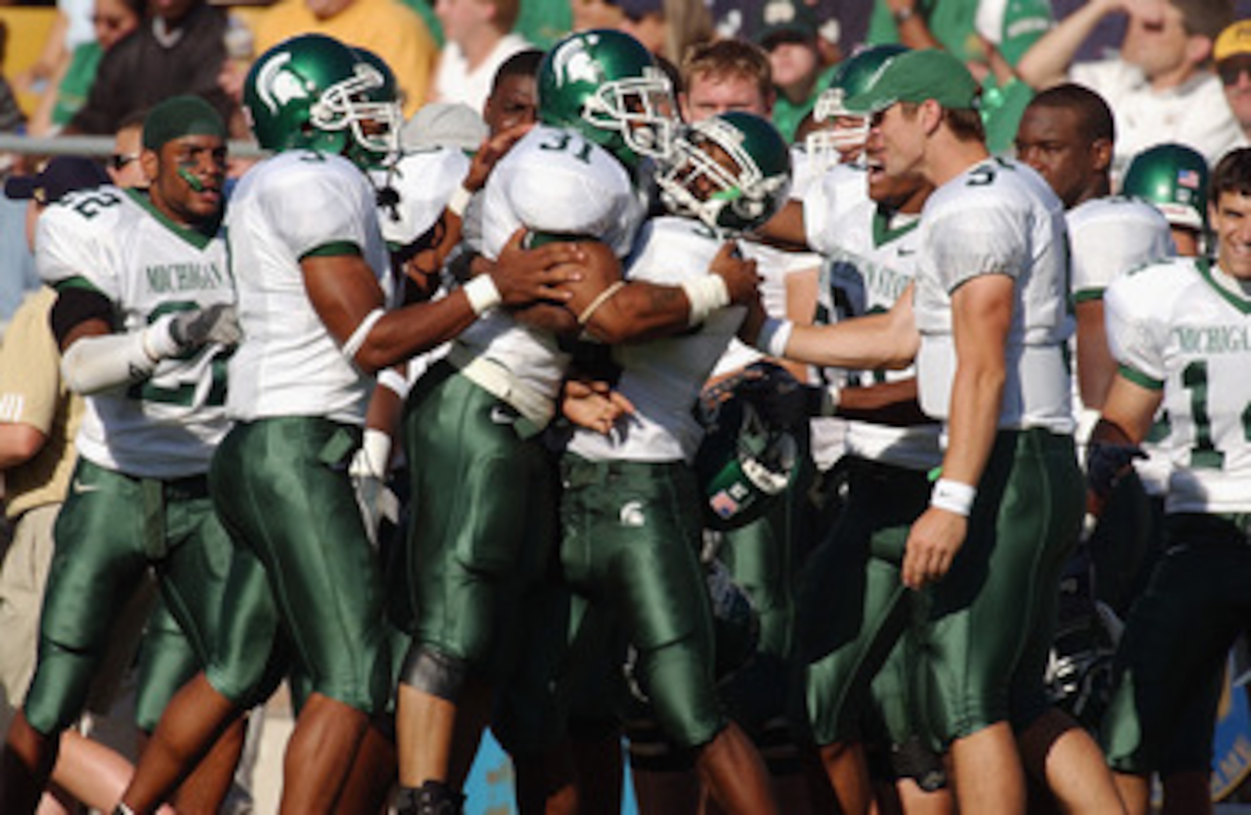 SOUTH BEND, IN - SEPTEMBER 20: Running back Jaren Hayes #31 of Michigan State is greeted with hugs from teammates after scoring on a 73 yard run against Notre Dame during a game on September 20, 2003 at the Notre Dame Stadium in South Bend, Indiana. Mich SOUTH BEND, IN - SEPTEMBER 20: Running back Jaren Hayes #31 of Michigan State is greeted with hugs from teammates after scoring on a 73 yard run against Notre Dame during a game on September 20, 2003 at the Notre Dame Stadium in South Bend, Indiana. Mich