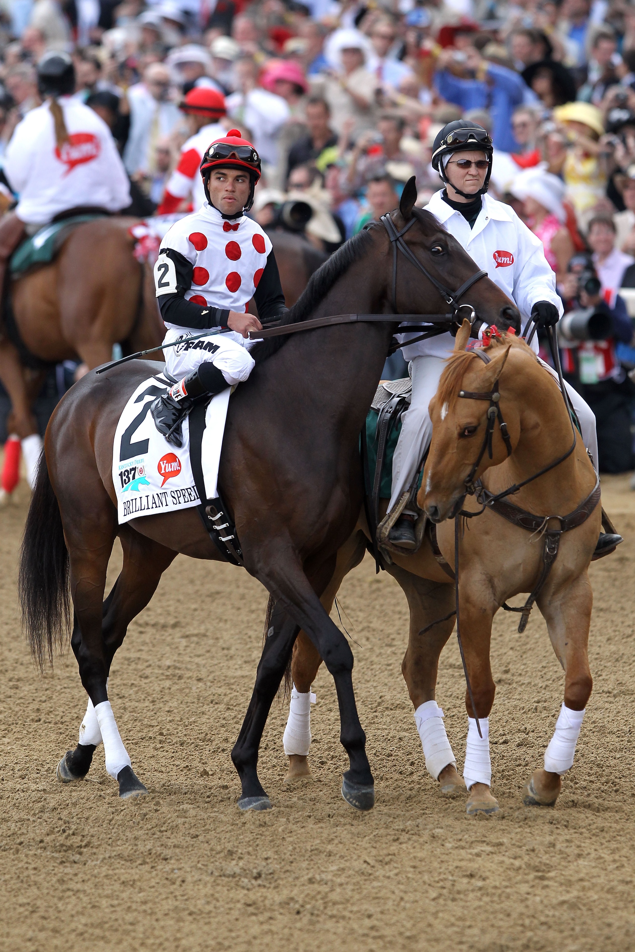LOUISVILLE, KY - MAY 07:  Jockey Joel Rosario, riding Brilliant Speed #2, is escourted onto the track by an outrider for the running of the 137th Kentucky Derby at Churchill Downs on May 7, 2011 in Louisville, Kentucky.  (Photo by Matthew Stockman/Getty I