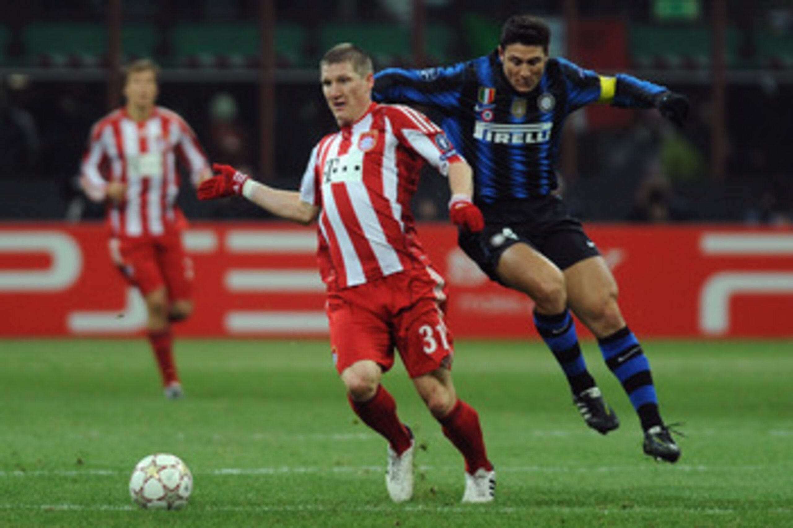 MILAN, ITALY - FEBRUARY 23:  Javier Zanetti of Inter Milan clashes with Bastian Schweinsteiger of FC Bayern Muenchen during the UEFA Champions League round of 16 first leg match between Inter Milan v FC Bayern Muenchen on February 23, 2011 in Milan, Italy