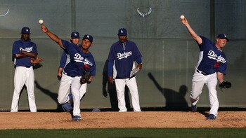 GLENDALE, AZ - MARCH 04:  Pitchers Carlos Monasterios #37 and Jon Link #50 of the Los Angeles Dodgers throw warm ups before the spring training game against the San Francisco Giants at Camelback Ranch on March 4, 2011 in Glendale, Arizona.  (Photo by Chri