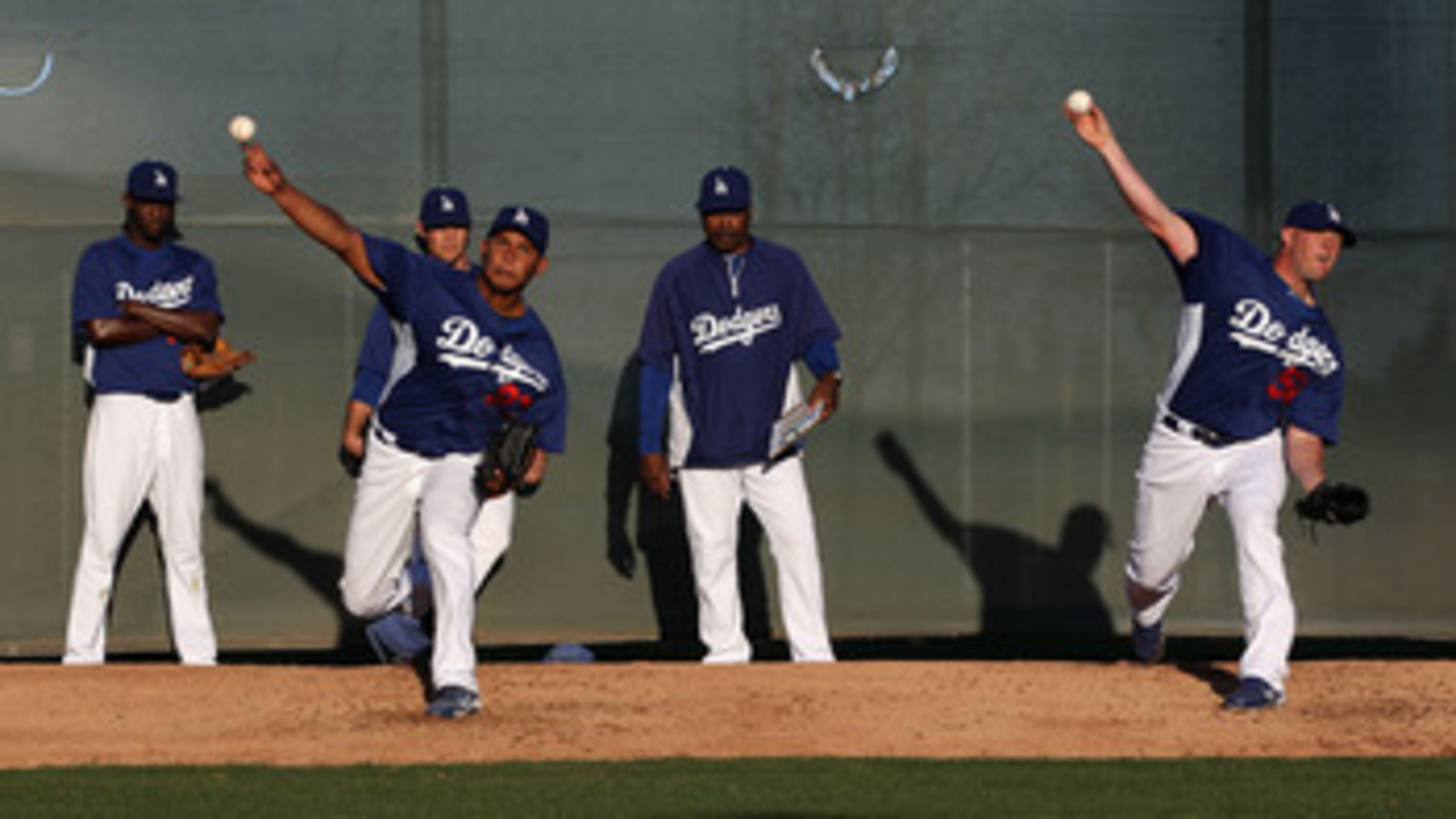 GLENDALE, AZ - MARCH 04:  Pitchers Carlos Monasterios #37 and Jon Link #50 of the Los Angeles Dodgers throw warm ups before the spring training game against the San Francisco Giants at Camelback Ranch on March 4, 2011 in Glendale, Arizona.  (Photo by Chri